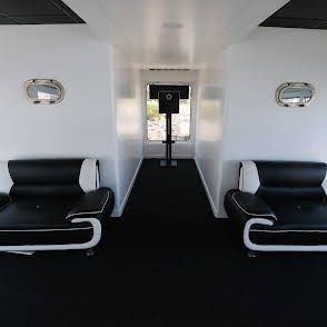 Interior of a 1977 Nichols Party boat with modern black seating.