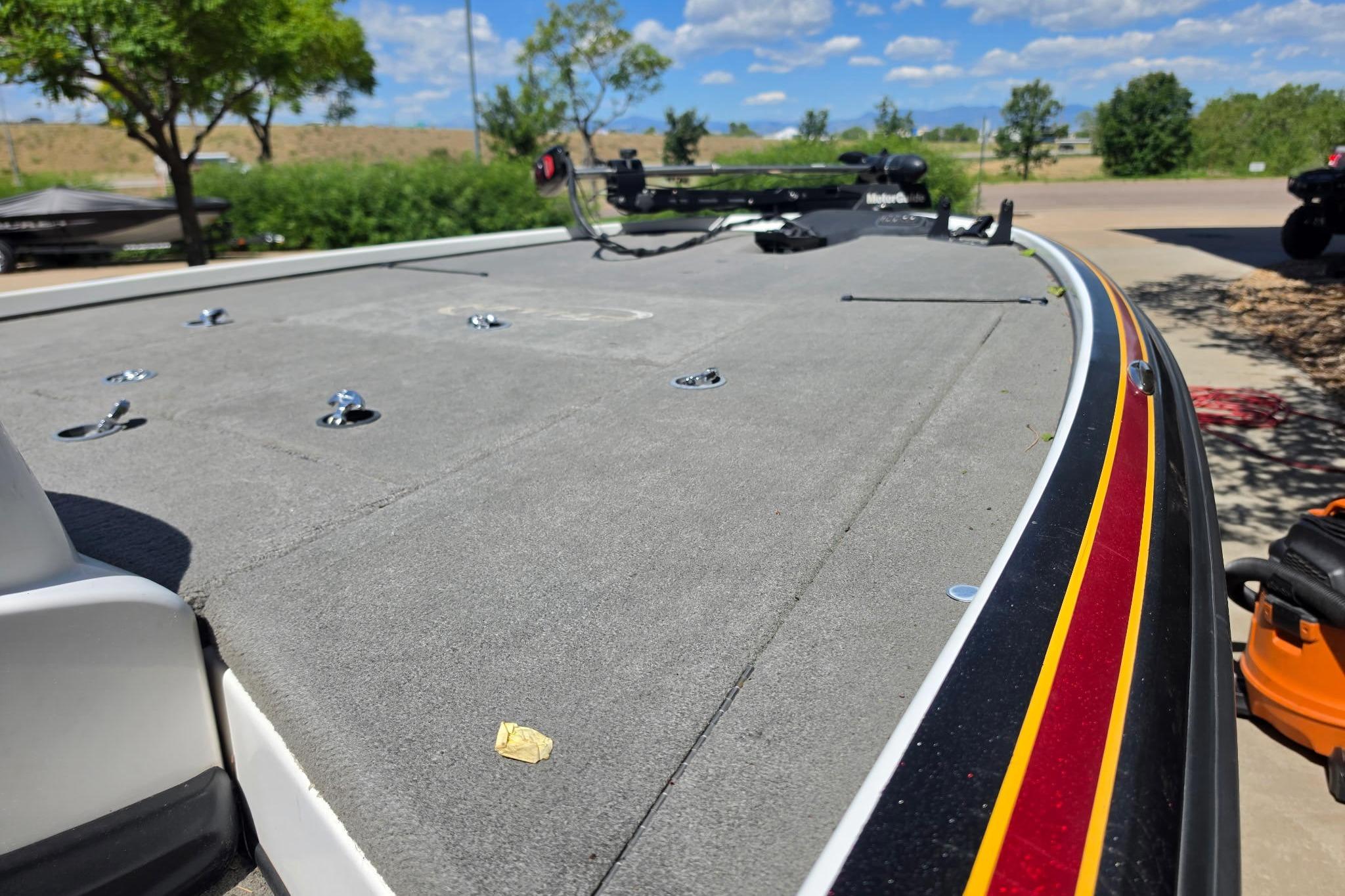 2008 Nitro Z-9 boat deck with red and yellow trim, parked outdoors.