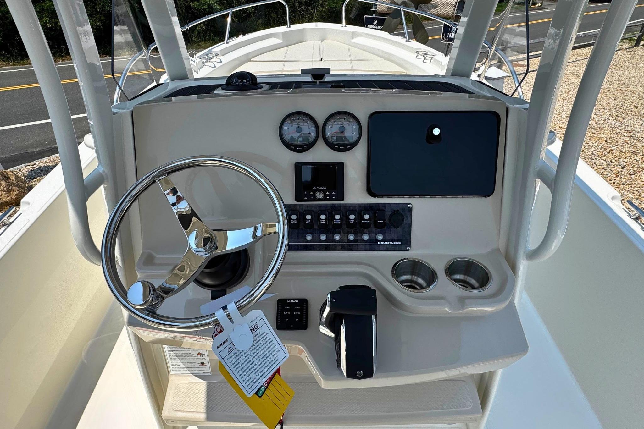 2026 Boston Whaler 220 Dauntless boat console with steering wheel and controls.