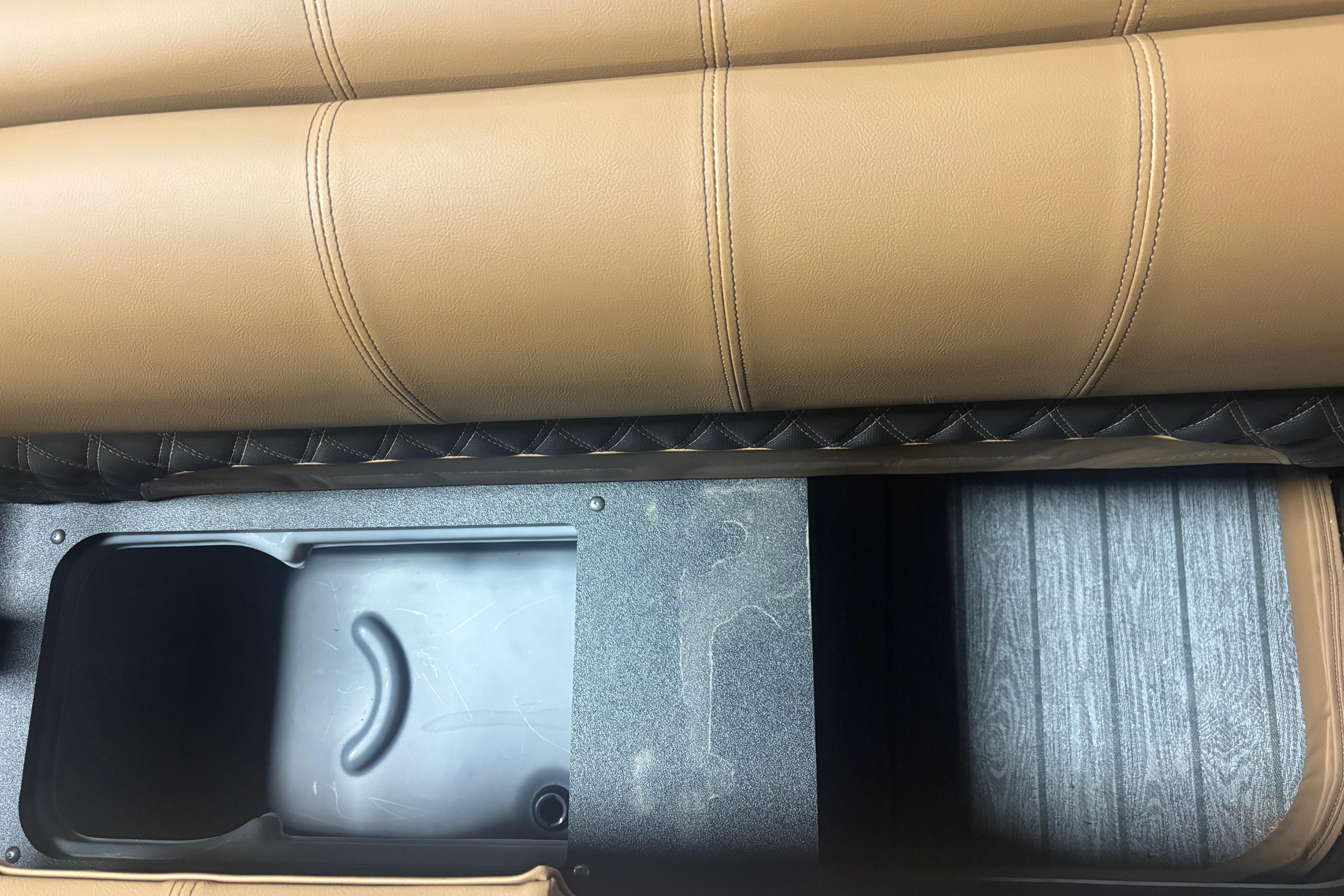Tan leather seating with storage compartment in 2026 Ranger 223F model.