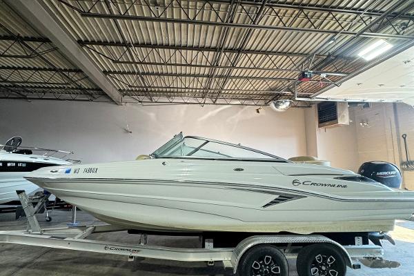 2023 Crownline 215 XS boat on trailer in indoor storage.