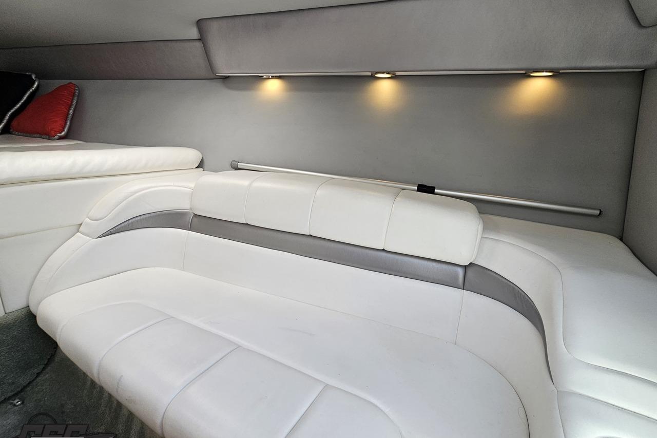 Interior of 2005 Formula 271 FASTech boat with white leather seating and ambient lighting.