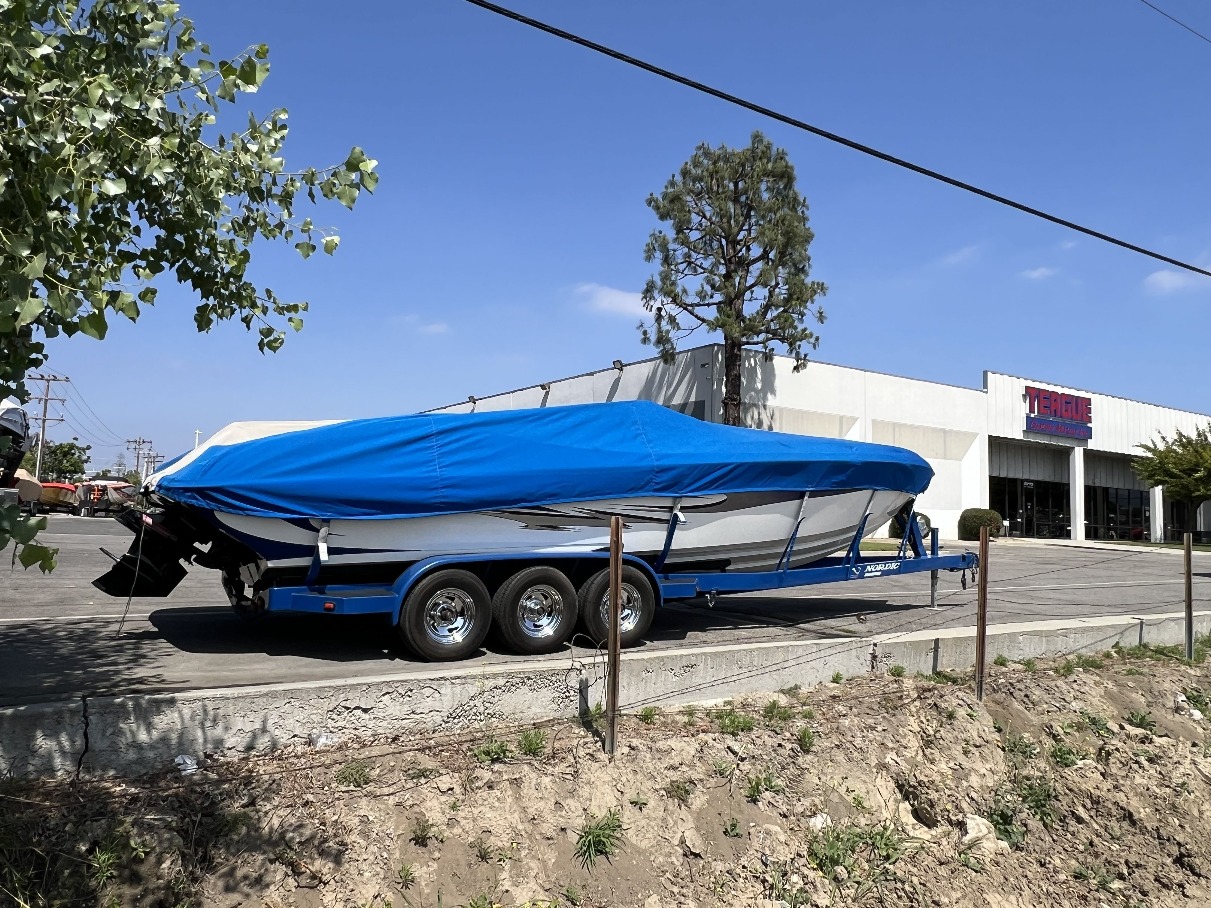 2007 Nordic Powerboats Heat with blue cover on trailer.