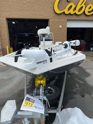 2024 Ranger RB210 boat with Minn Kota motor on trailer outside Cabela's store.