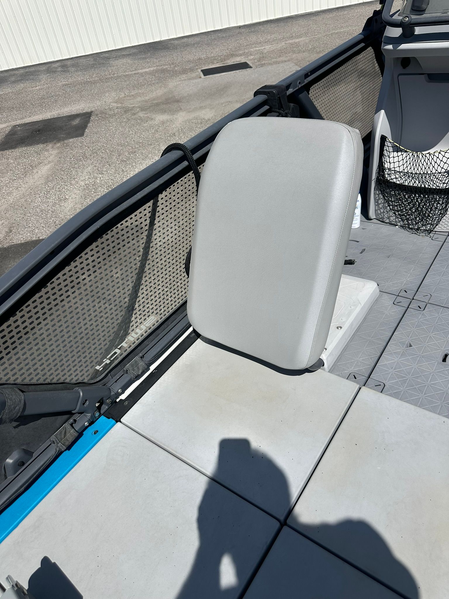 A seat on a 2023 Sea-Doo 21 SWITCH SPORT, featuring gray upholstery and a mesh storage pocket.
