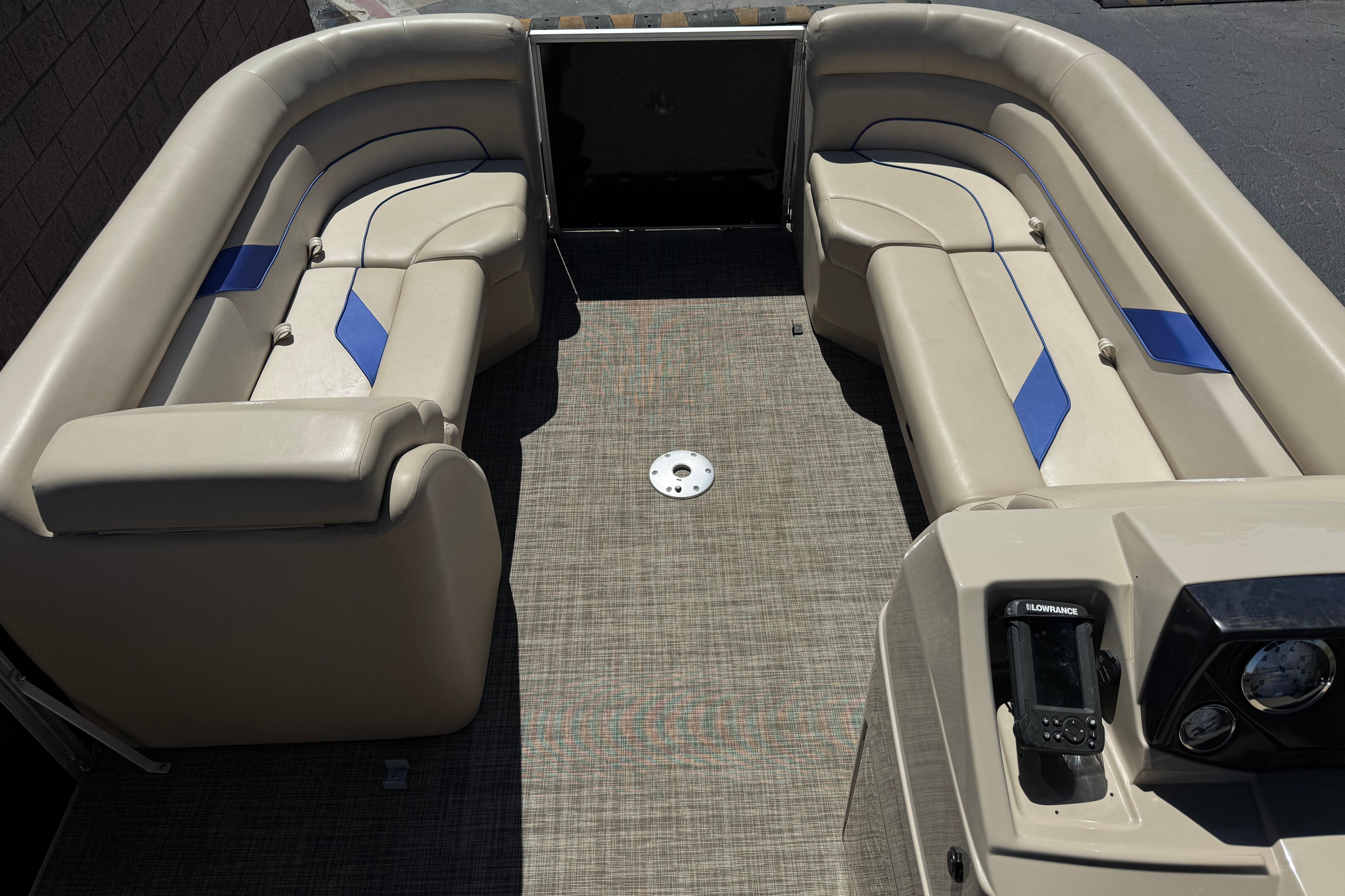 2021 SunCatcher Select 20RCX pontoon boat interior with beige seating and blue accents.
