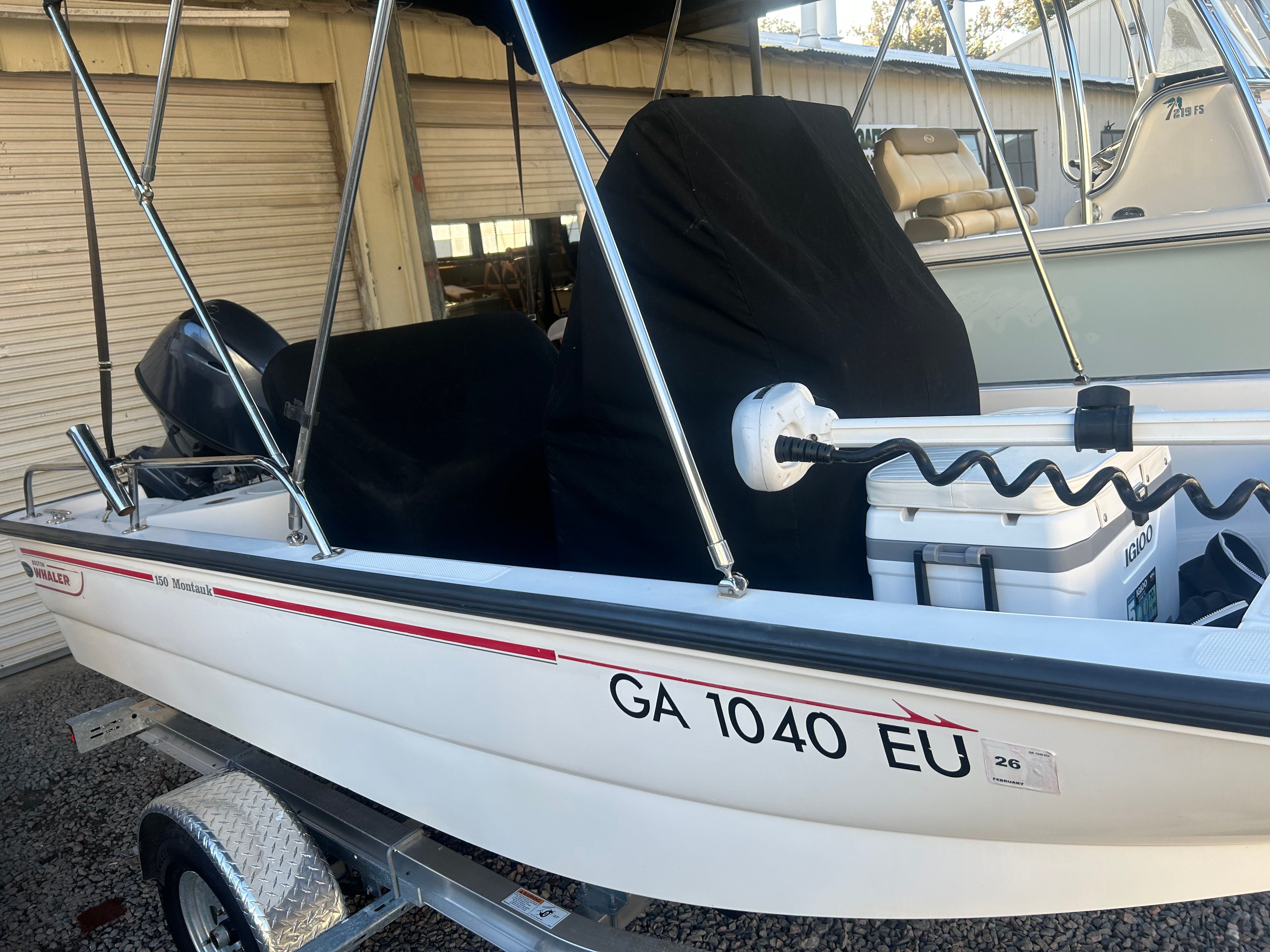 2006 Boston Whaler 150 Montauk on trailer, side view.