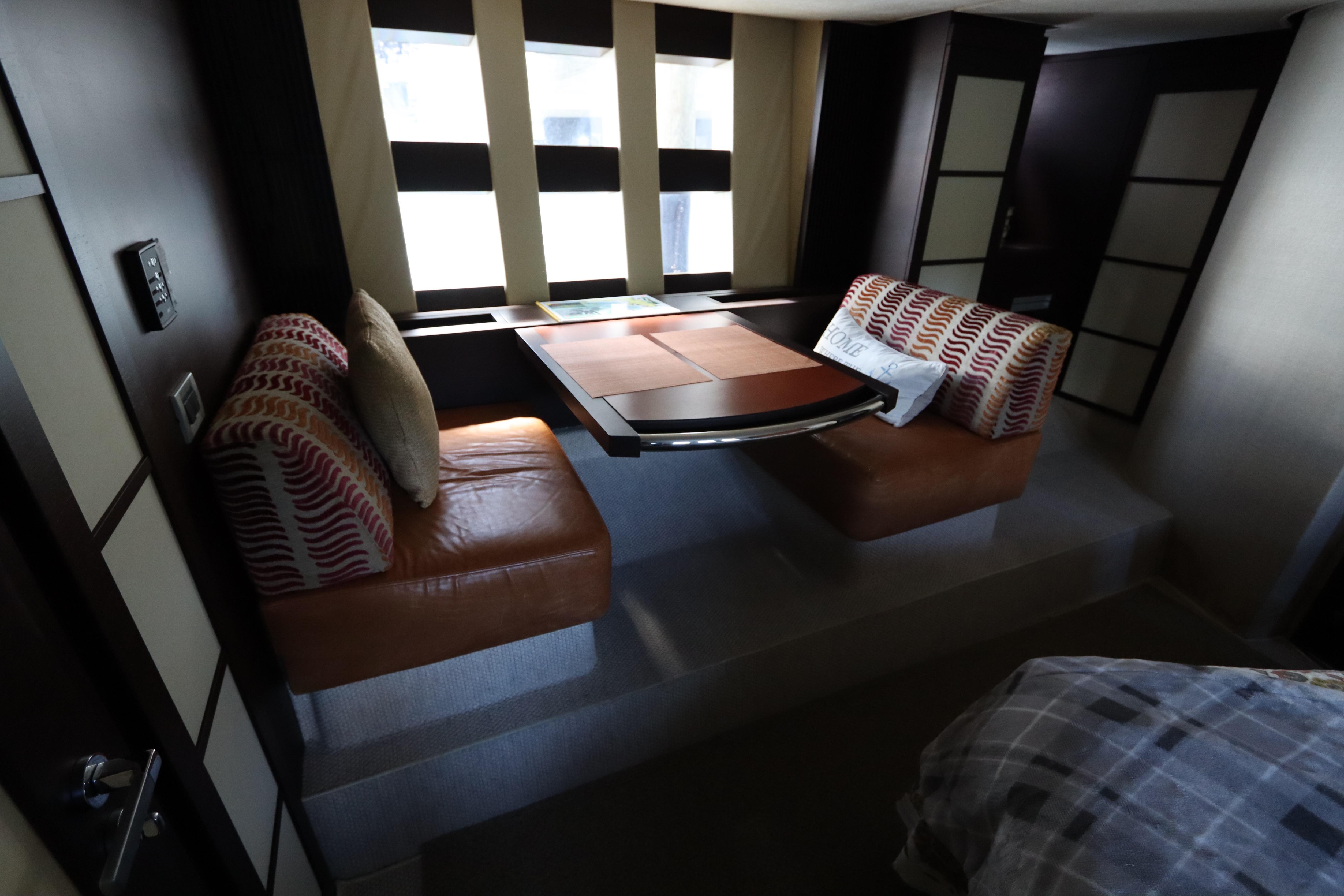 Luxurious interior of 2007 Azimut 62S yacht with cozy seating and modern design.