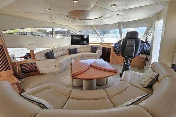 Luxurious interior of 2005 Sunseeker Manhattan 66 yacht with plush seating and helm station.