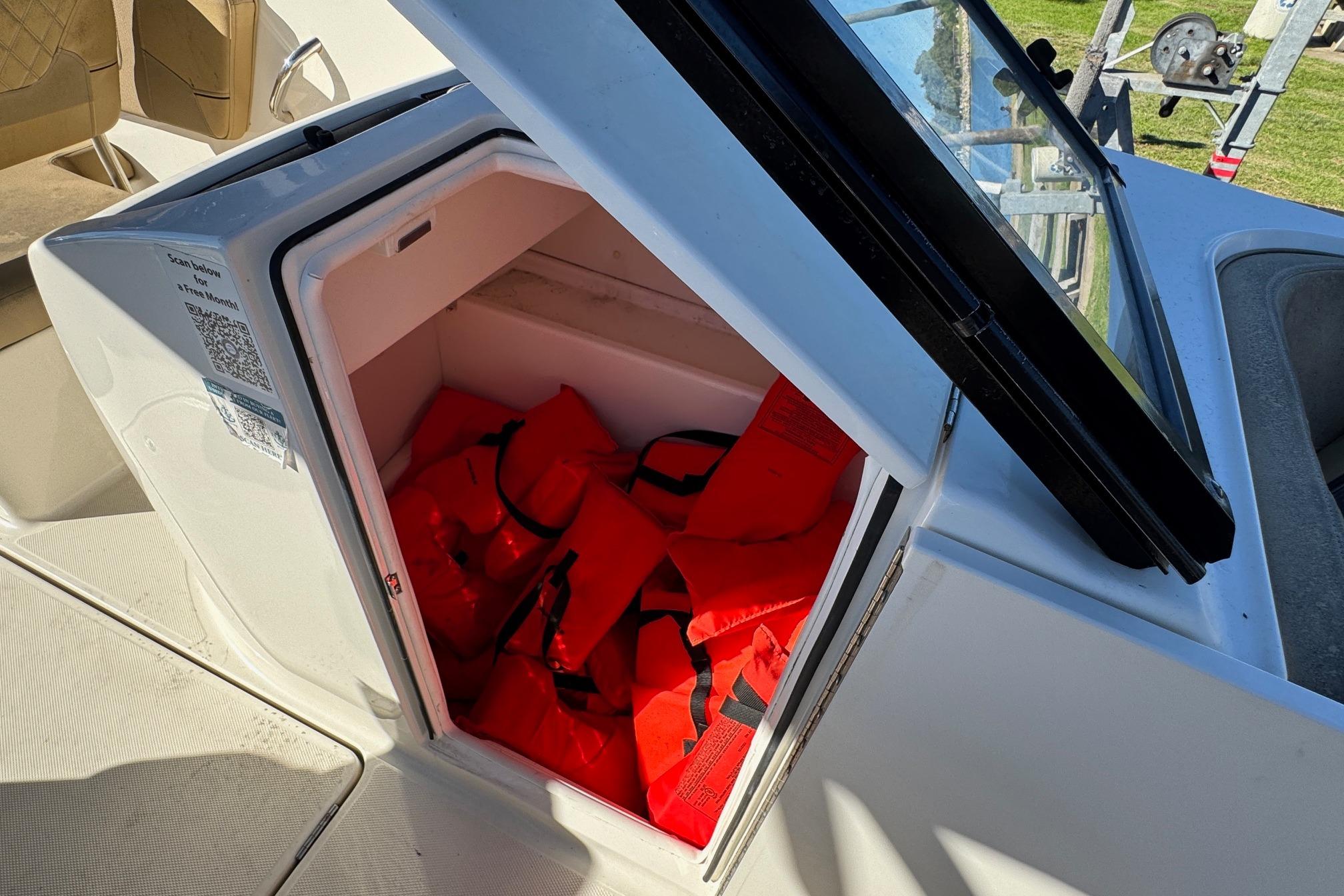 2022 Bayliner VR6 Bowrider OB storage compartment with life jackets inside.