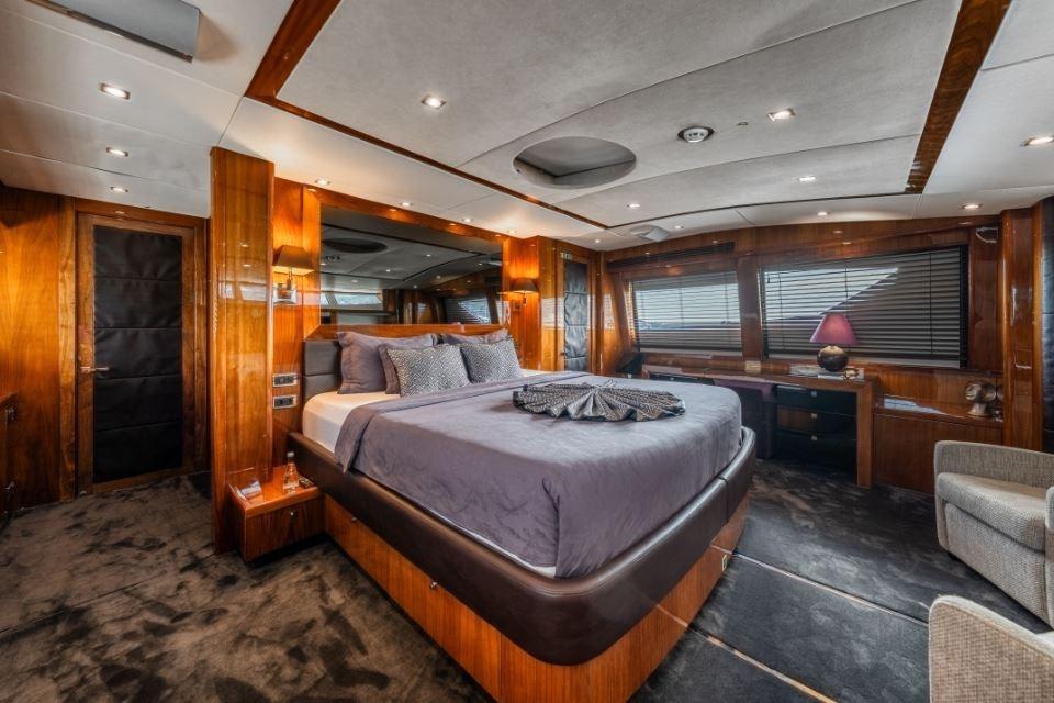 Luxurious bedroom interior on 2009 Sunseeker 34 Metre Yacht, featuring elegant wood finishes and modern decor.
