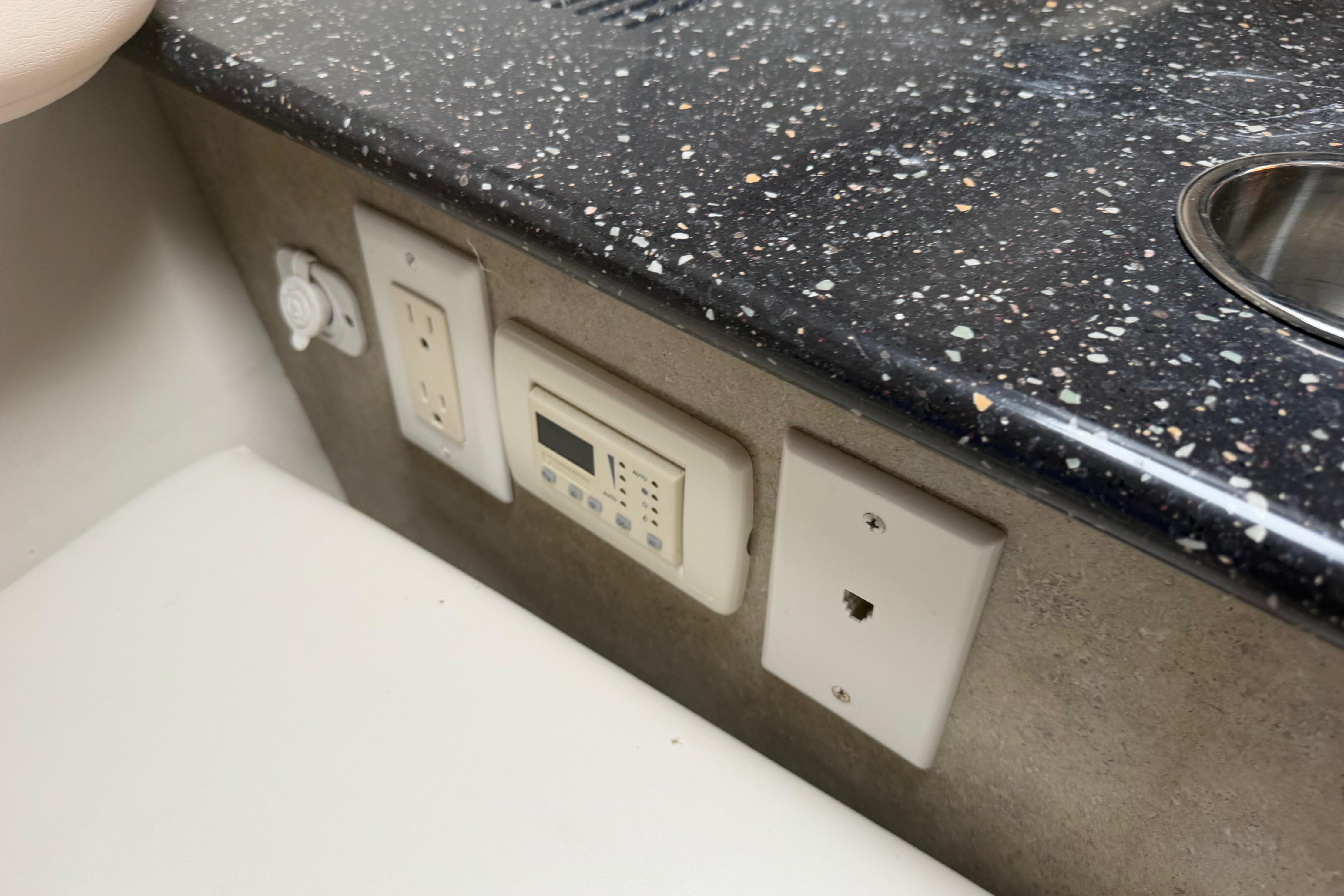 2006 Formula 330 Sun Sport interior with granite countertop and control panel.