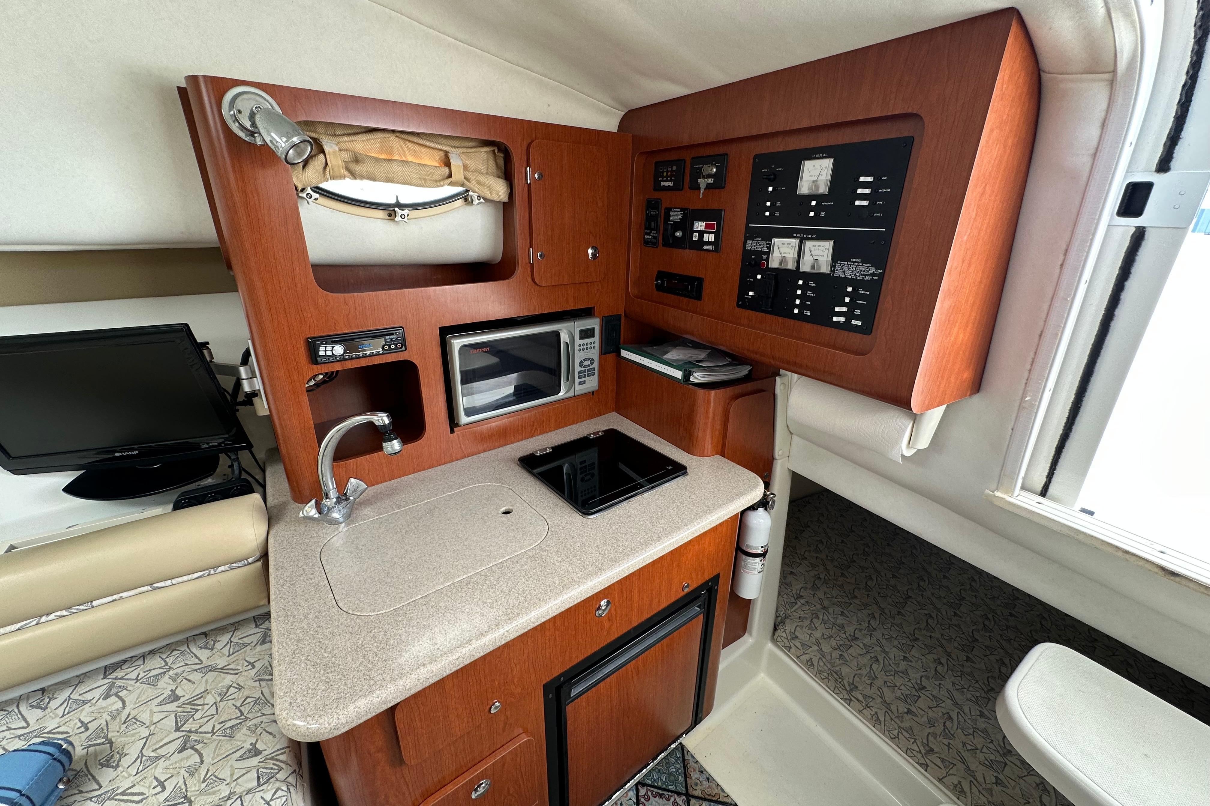 2006 Pro-Line 32 Express boat interior with kitchenette, microwave, and control panel.