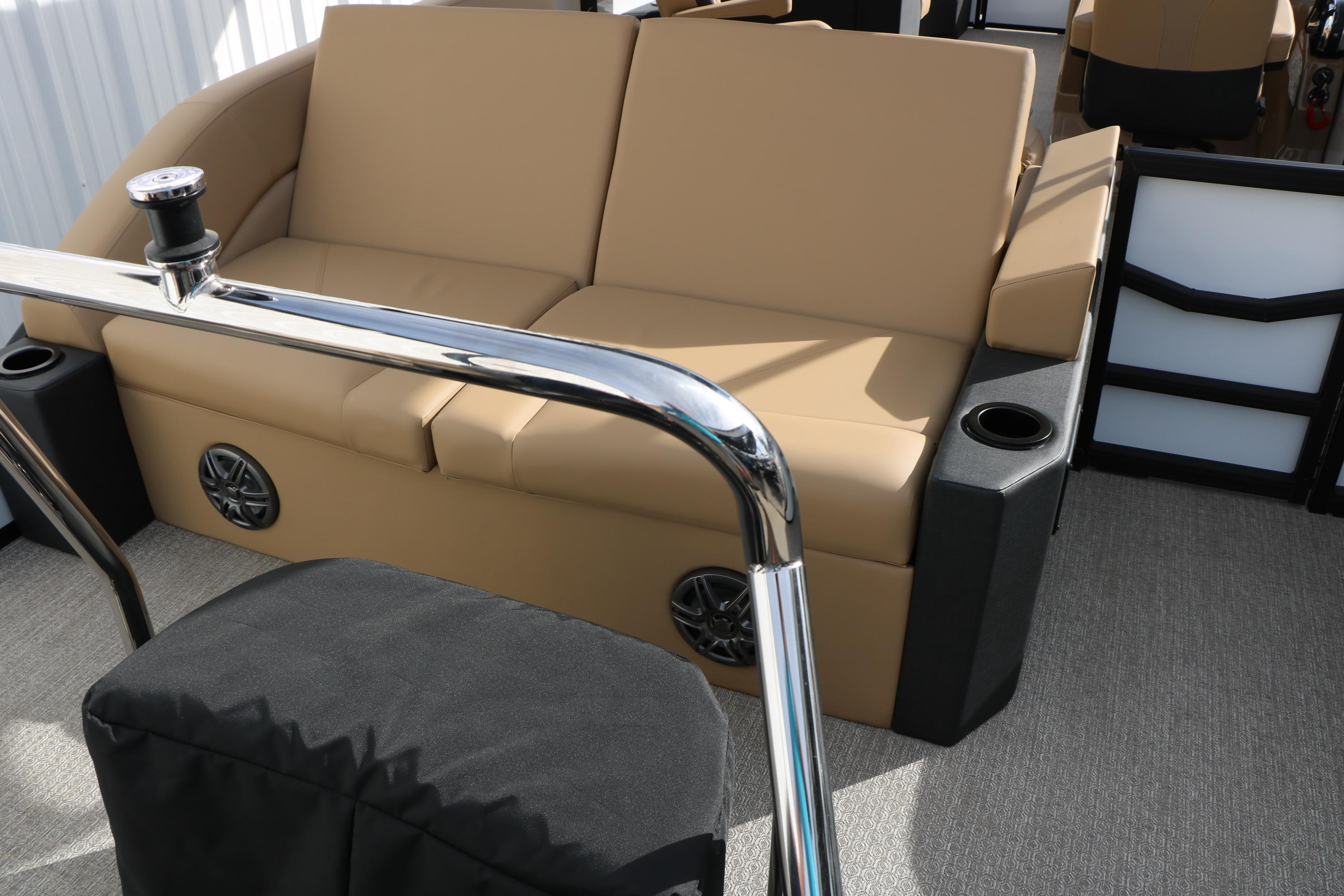 Luxurious seating on 2026 Evotti 523CS boat with cup holders and speakers.