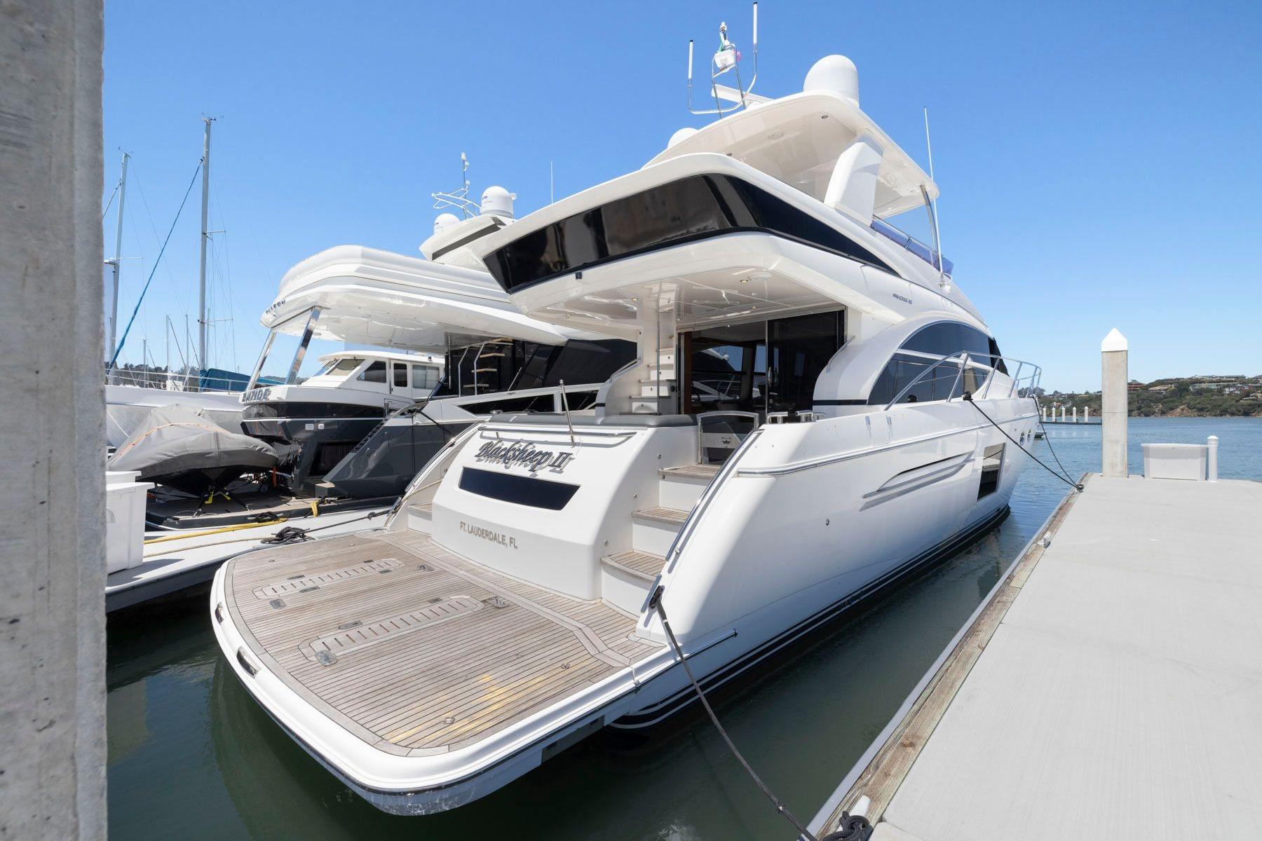 2015 Princess 60 Flybridge Motor Yacht docked at marina, showcasing sleek design and luxury features.