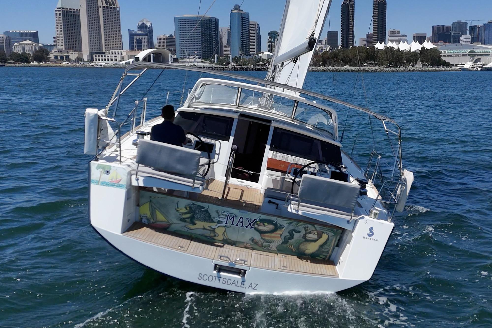 Sailing yacht Beneteau Sense 50, 2017 model, cruising near city skyline.