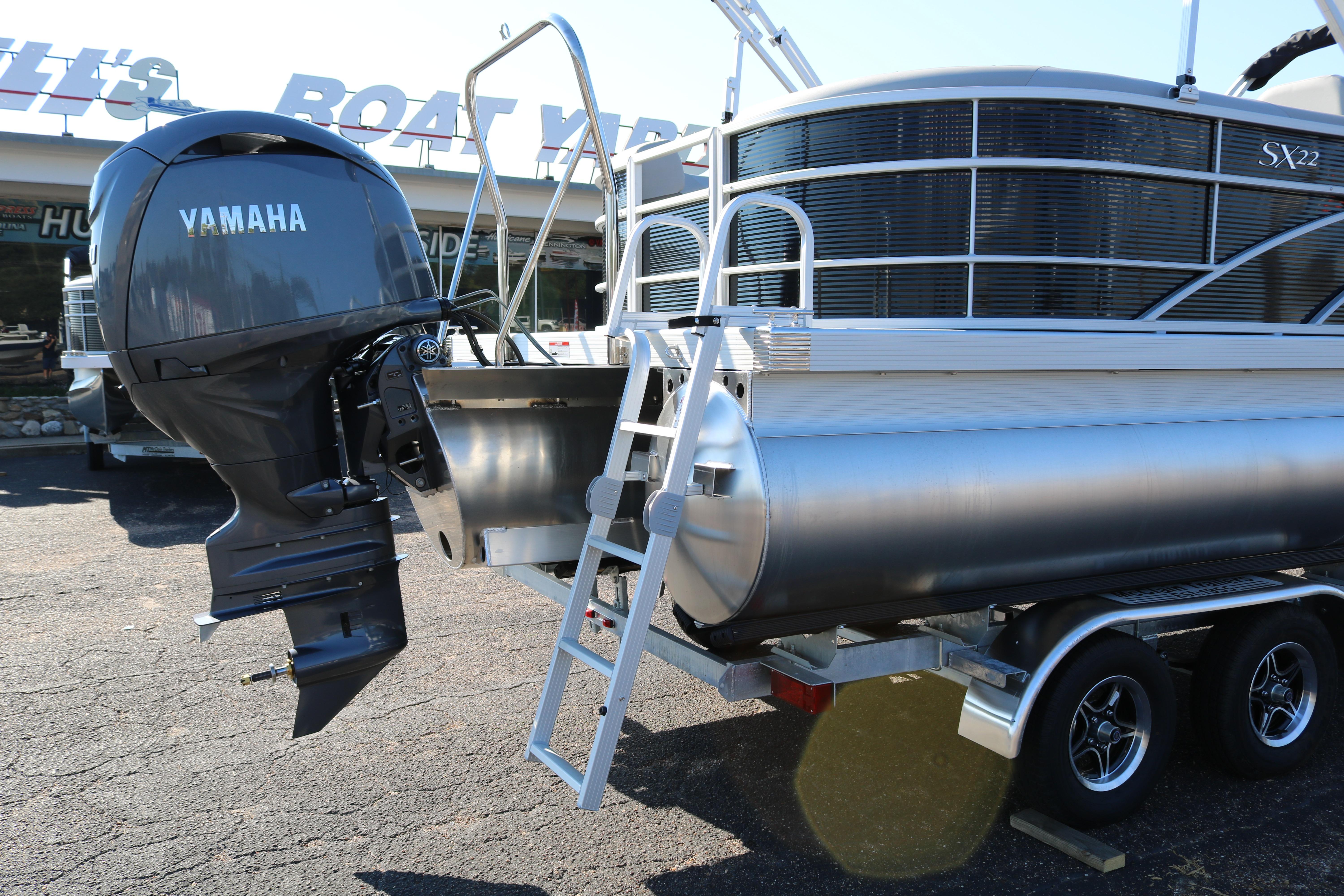 2026 Bennington 22SX Stern Radius pontoon boat with Yamaha outboard motor on trailer.