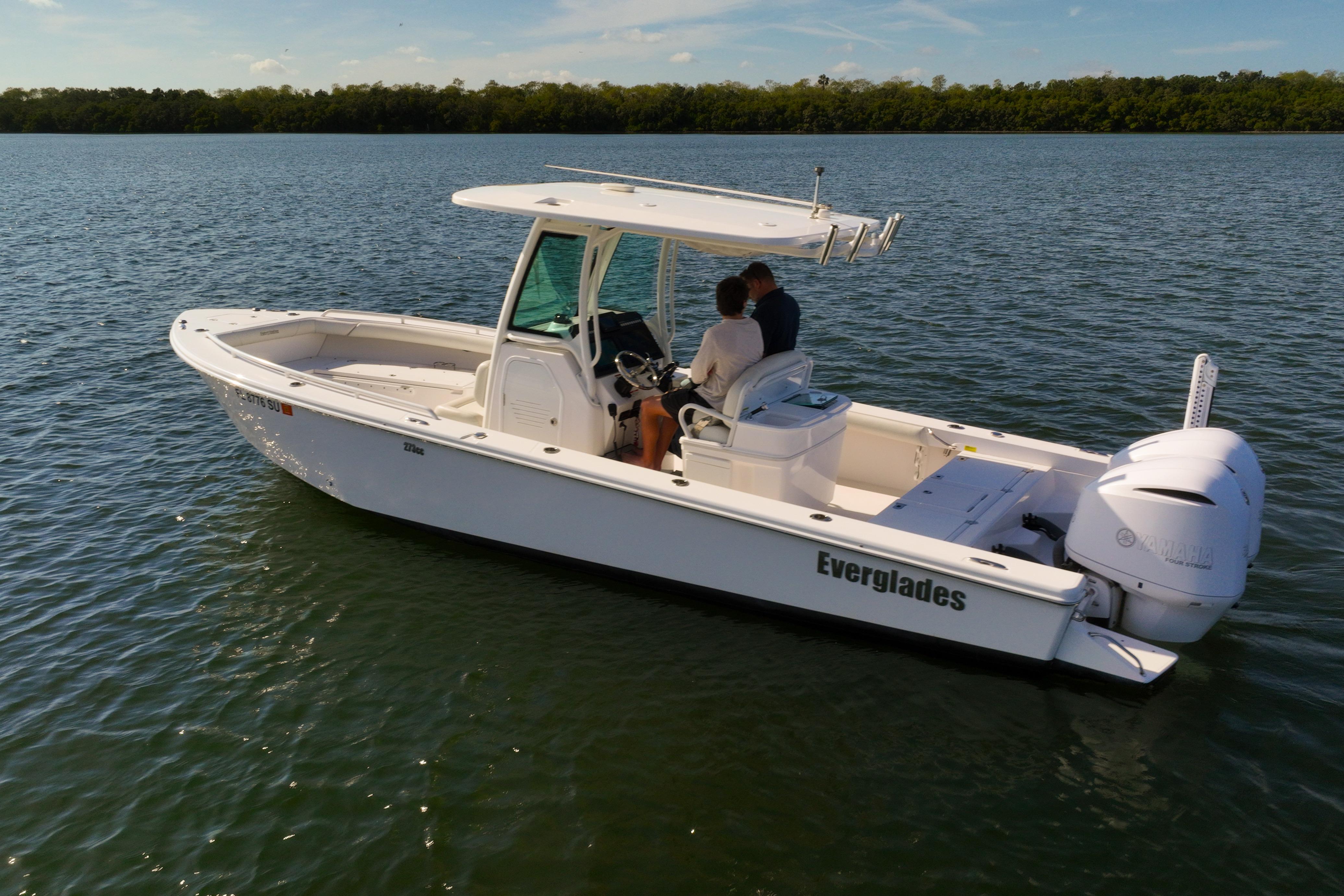 2021 Everglades 273 Center Console boat on calm water, featuring sleek design and powerful engine.