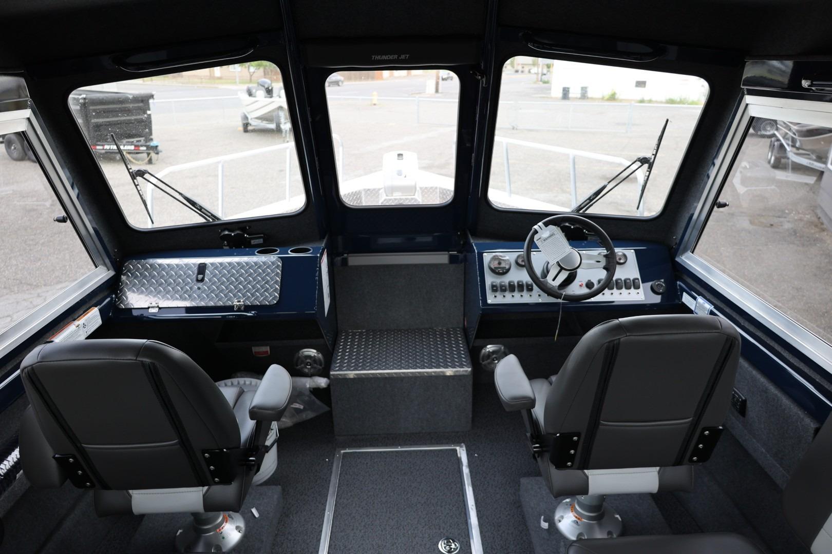 Interior of 2026 Thunder Jet 24 Alexis Pro boat, featuring dual seats and control panel.