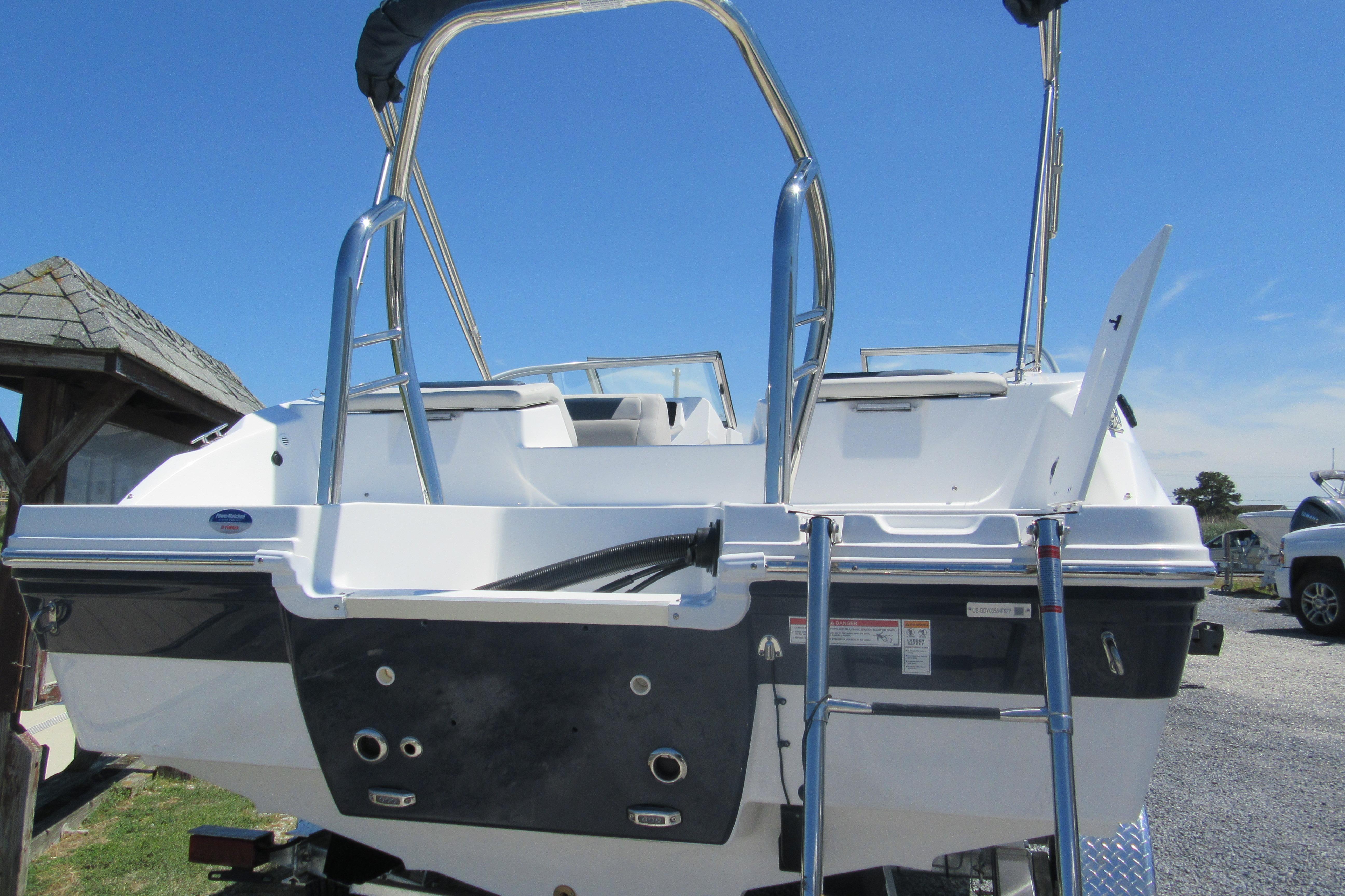 2027 Hurricane SunDeck 2050 OB boat with sleek design and stainless steel ladder.