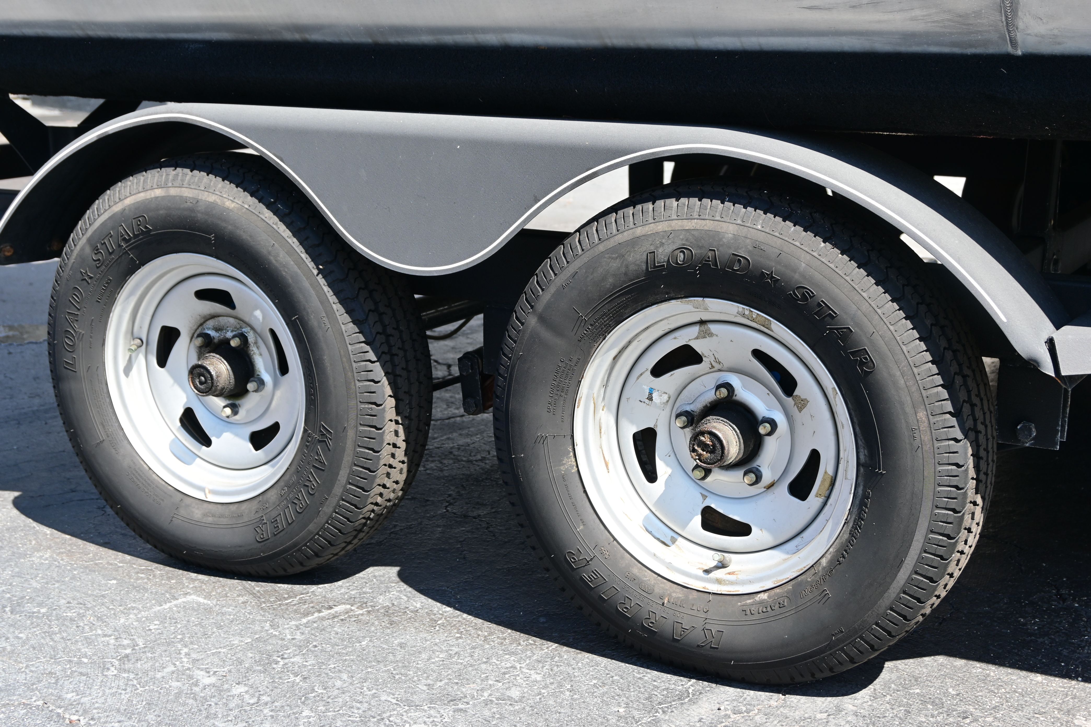 Close-up of Sun Tracker FISHI 2019 trailer wheels.