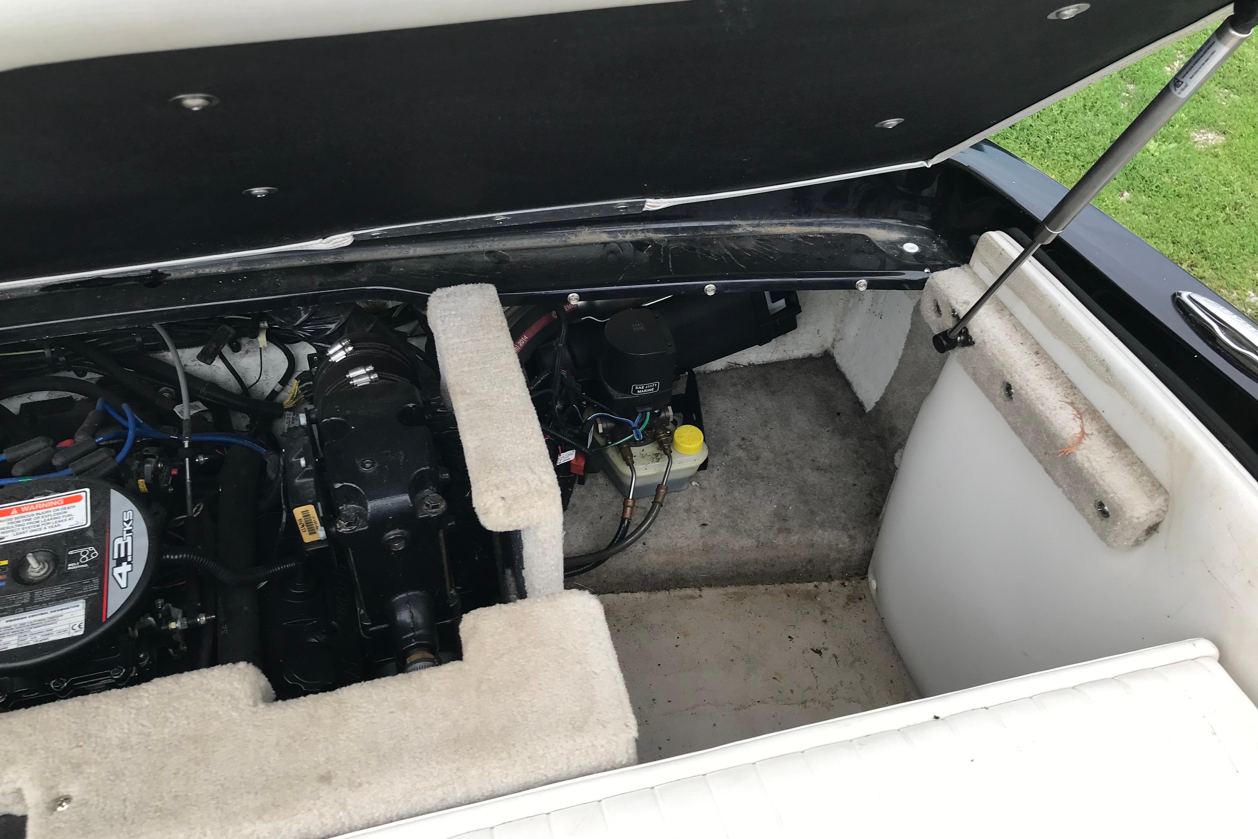 Open engine compartment of 2015 Crownline 18 SS boat, showing engine and components.