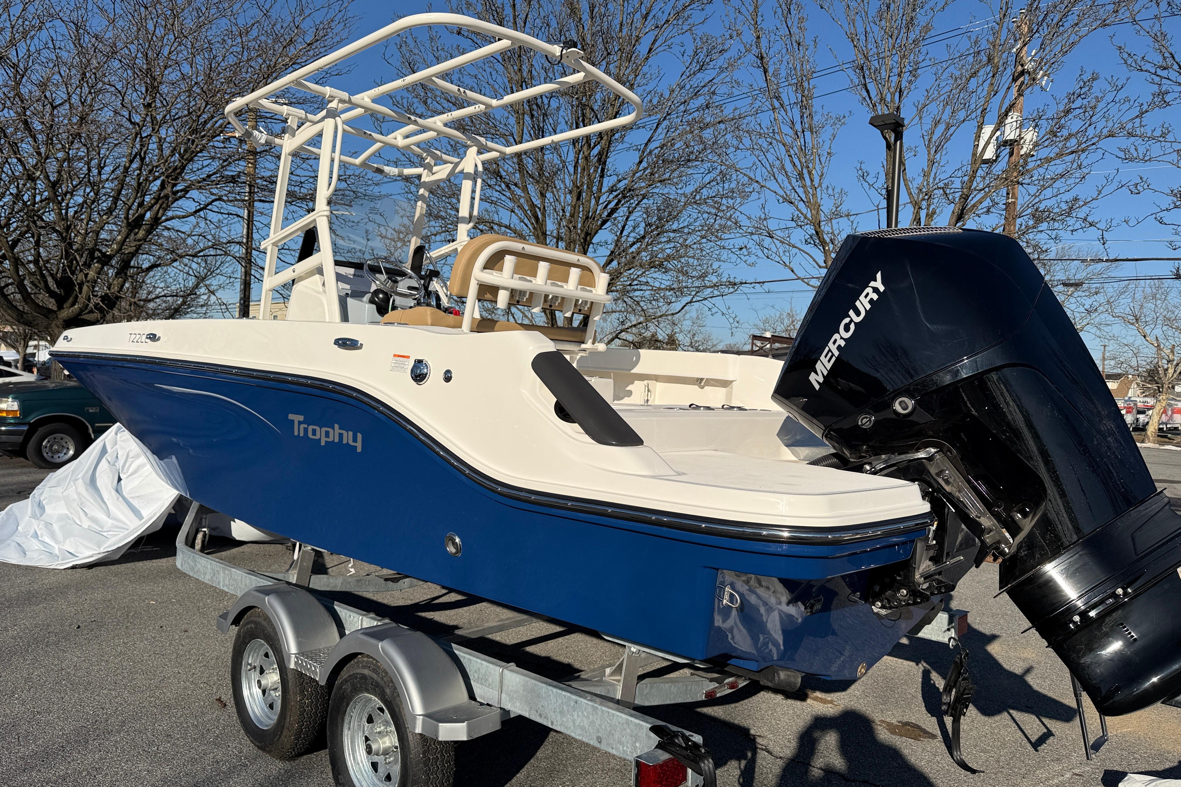 2026 Bayliner Trophy T22CC boat on trailer with Mercury outboard motor.