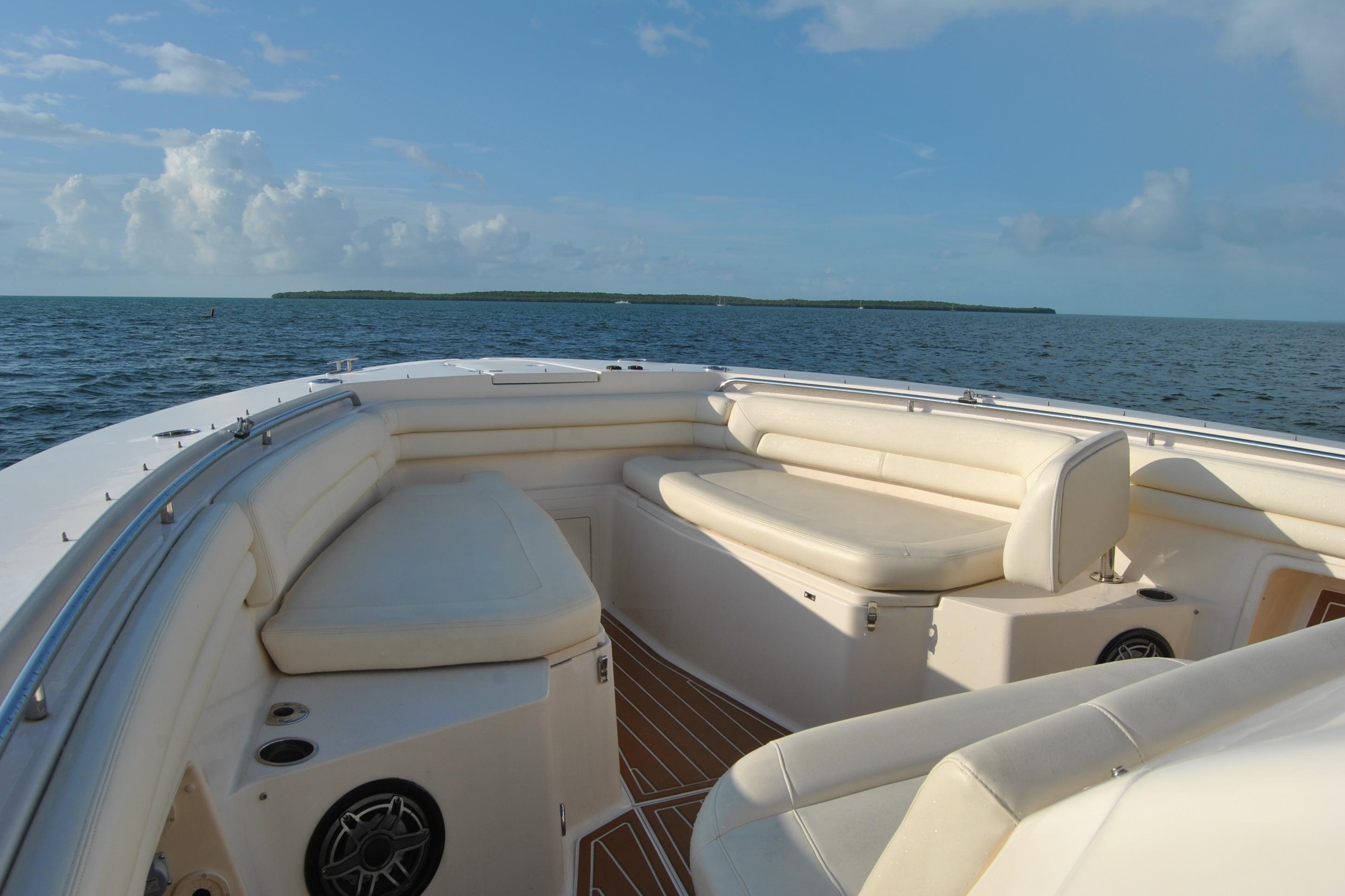 2018 Grady-White Canyon 376 boat interior with cushioned seating, ocean view, and clear sky.