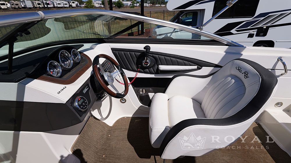 Interior of a 2014 Sea Ray SLX 230 with white seating and dashboard.