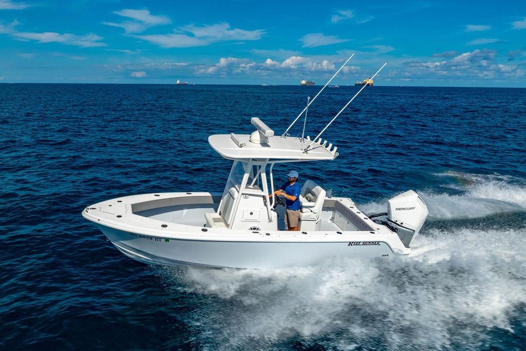 2024 Reef Runner 230 Open boat cruising on open ocean waters.
