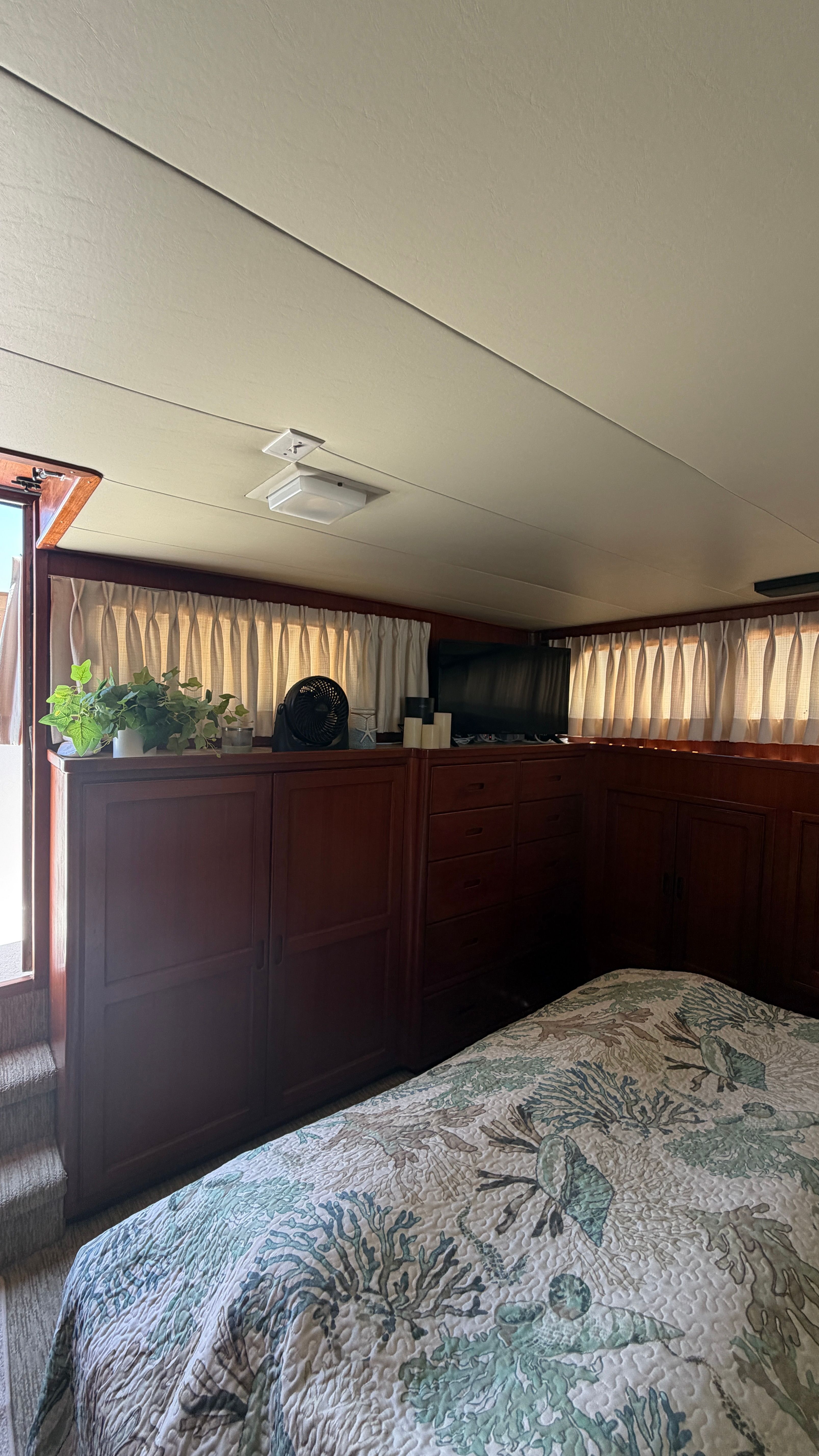 Interior of a 1966 Drake Yachtfisher with wooden furniture and bed.
