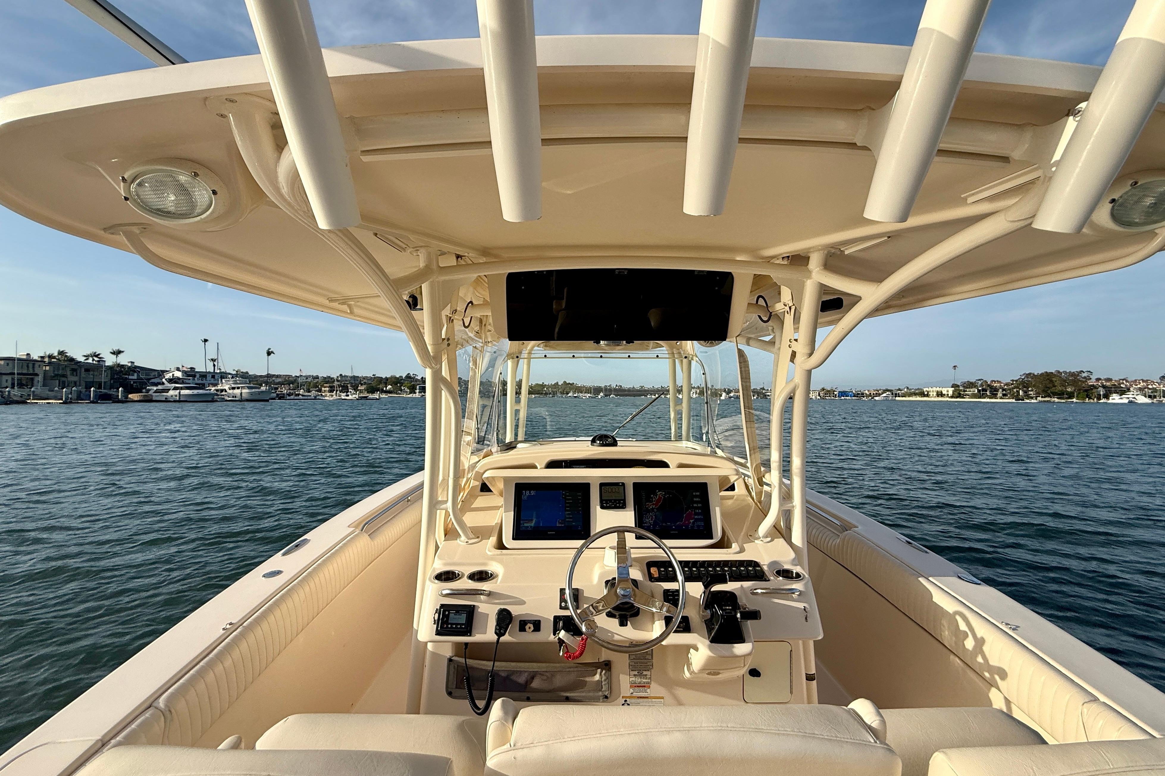 2012 Grady-White Canyon 336 boat interior with helm, on calm water.