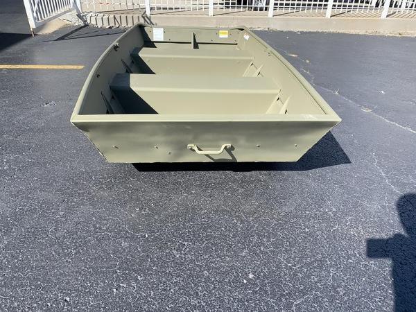 2024 Lowe L1040 Jon boat on pavement, showcasing its sturdy design.