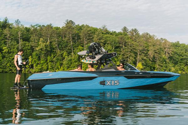 Manufacturer Provided Image: 2021 Axis A24 boat on a lake with wakeboarders.