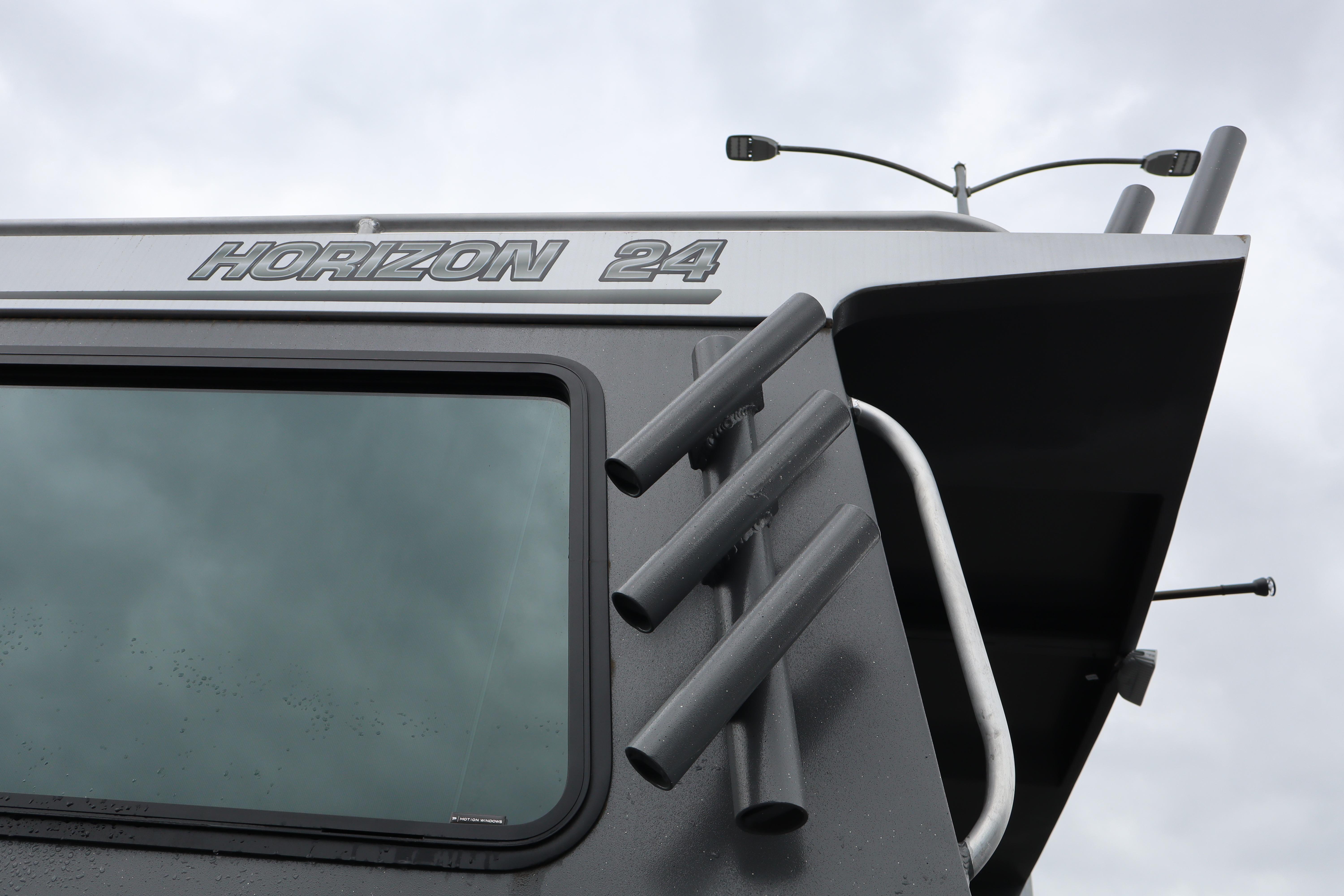 2026 Alumaweld Horizon 24 boat detail with rod holders and window.