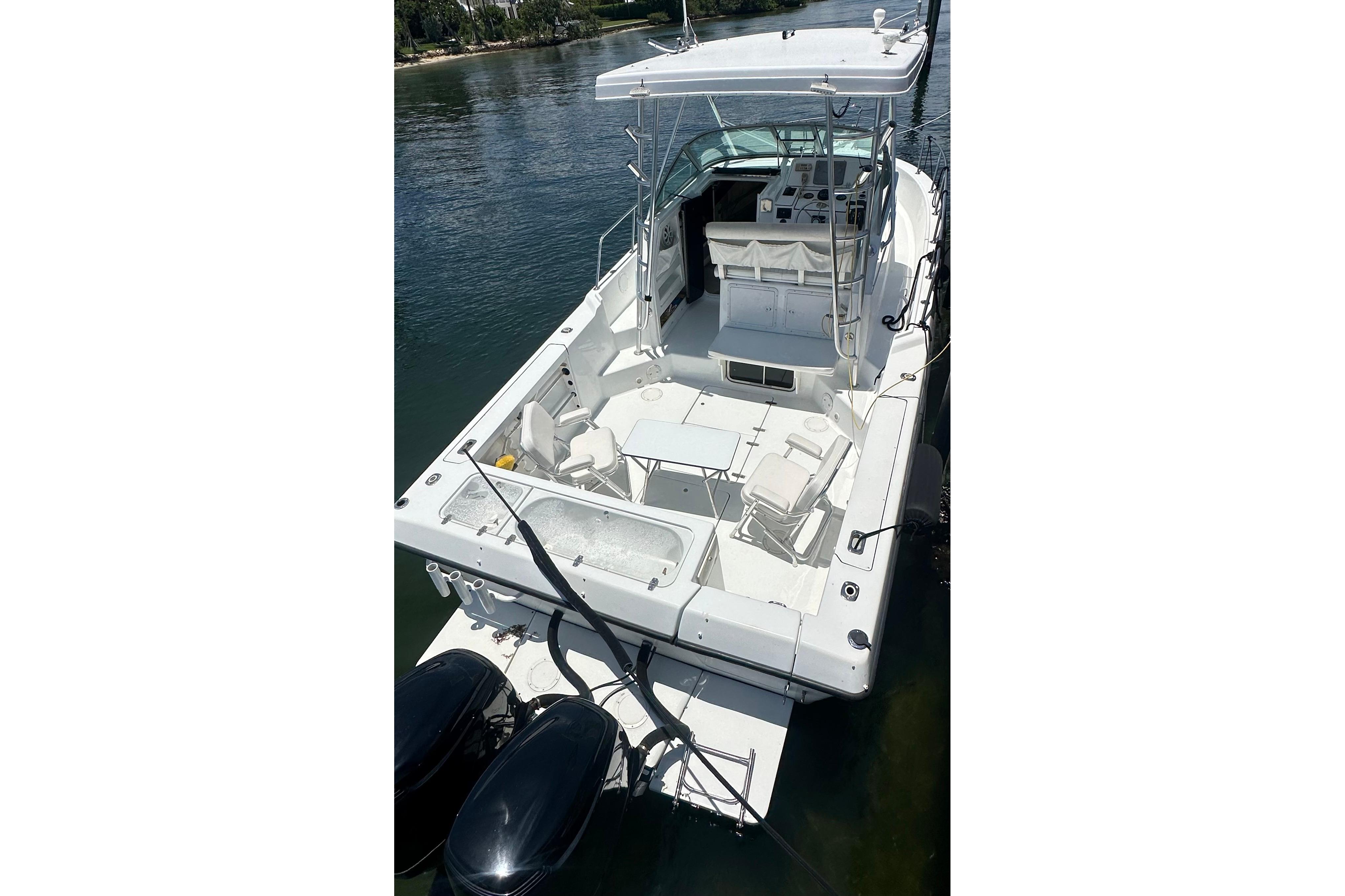 1994 Pro-Line 2950 Walkaround boat with spacious deck and dual outboard motors.