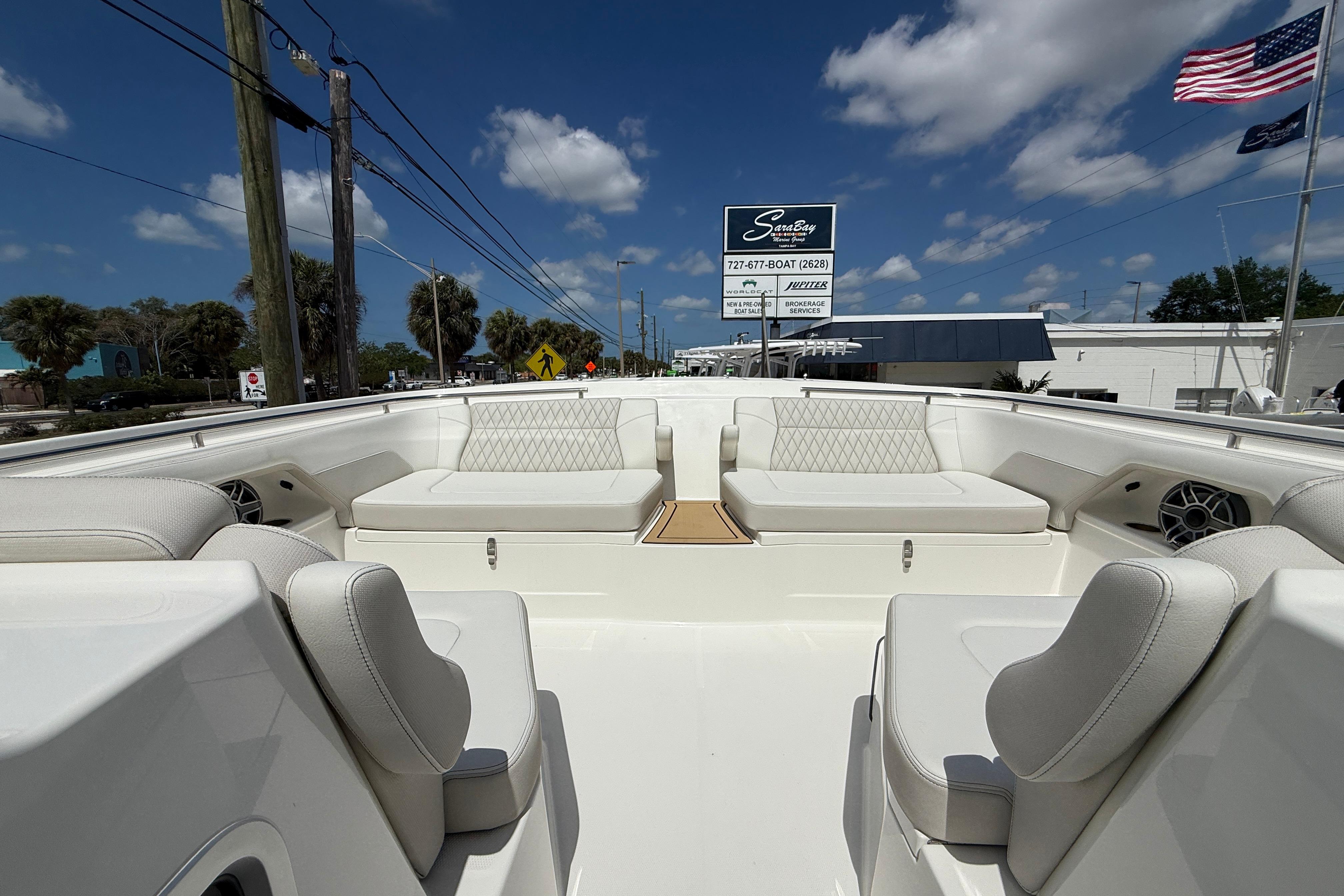 2026 World Cat 400 DC-X Island boat with luxurious seating, displayed outdoors under a clear sky.