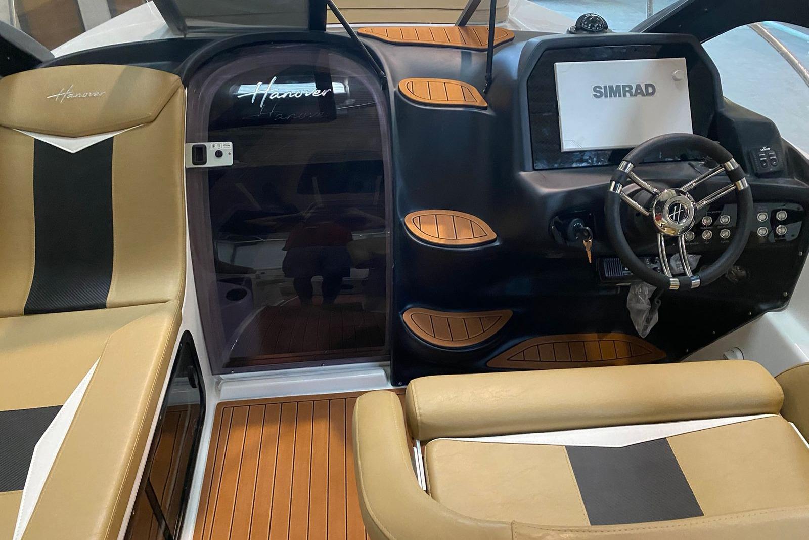 Interior of 2026 Hanover 305 boat with Simrad navigation system and luxury seating.