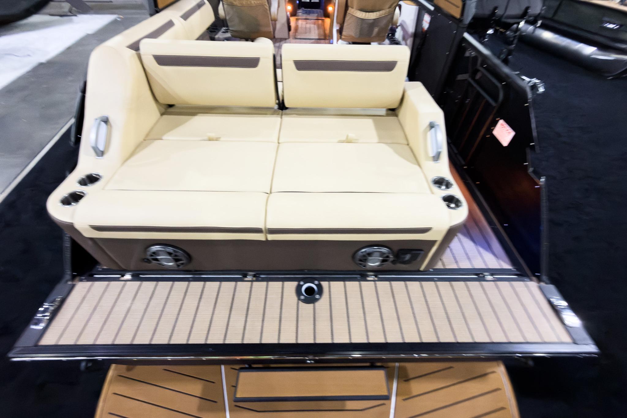 2026 Montara Surf Boss EVO SLDH 25' boat interior with beige seating and cup holders.