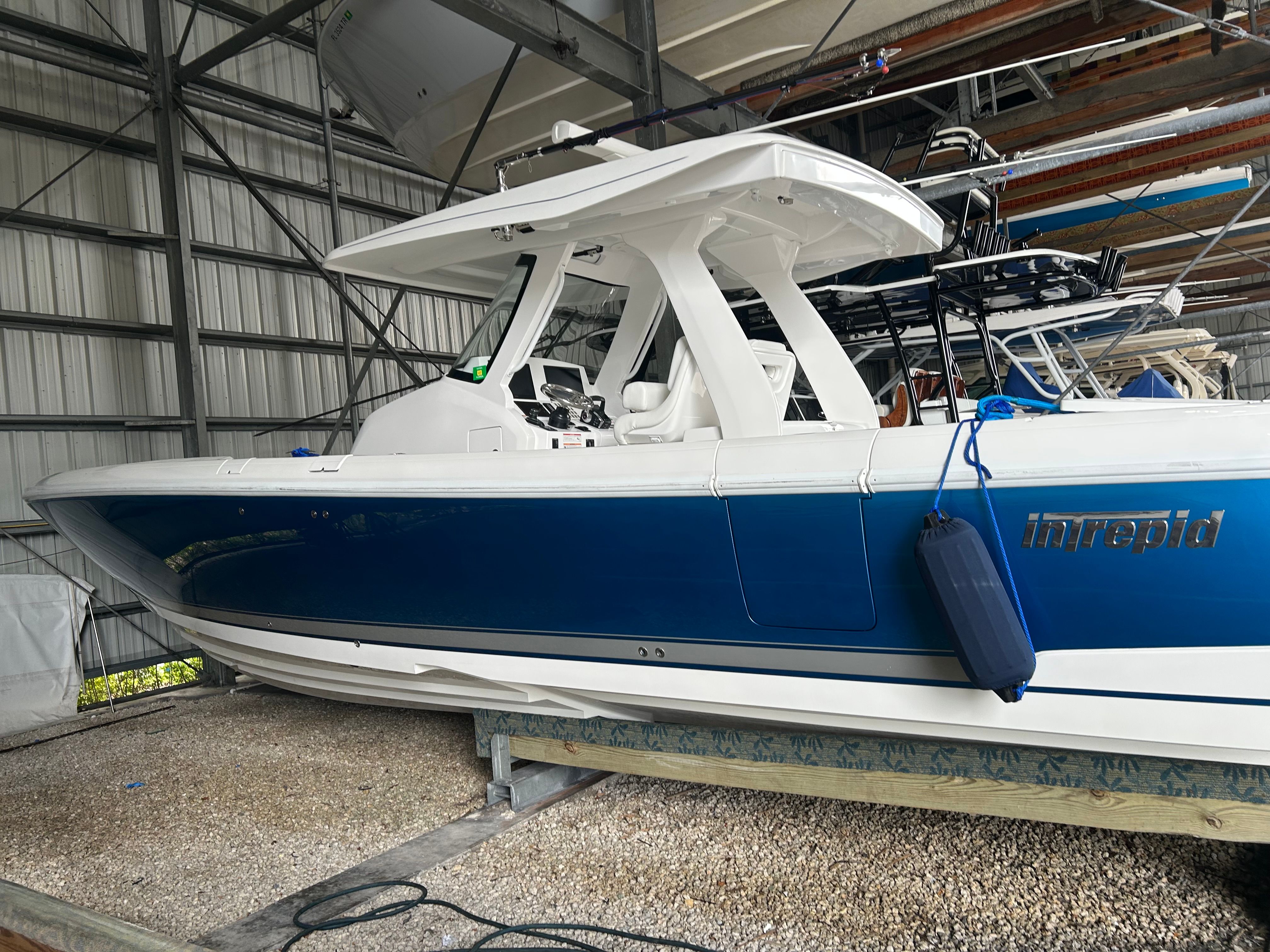 Intrepid 375 Nomad SE 2025 in a boat storage facility.