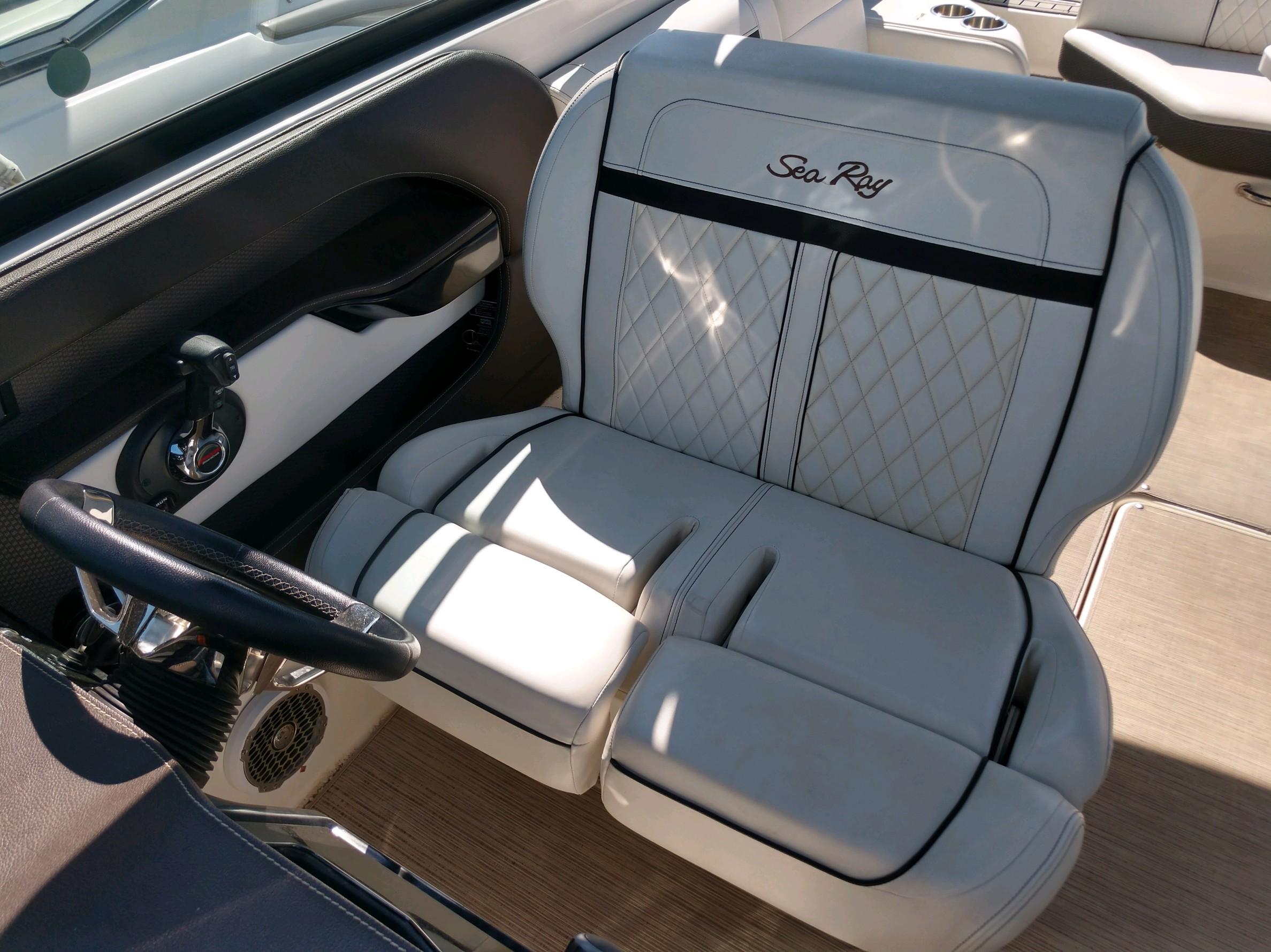 2018 Sea Ray SLX 280 boat interior with luxurious seating and steering wheel.