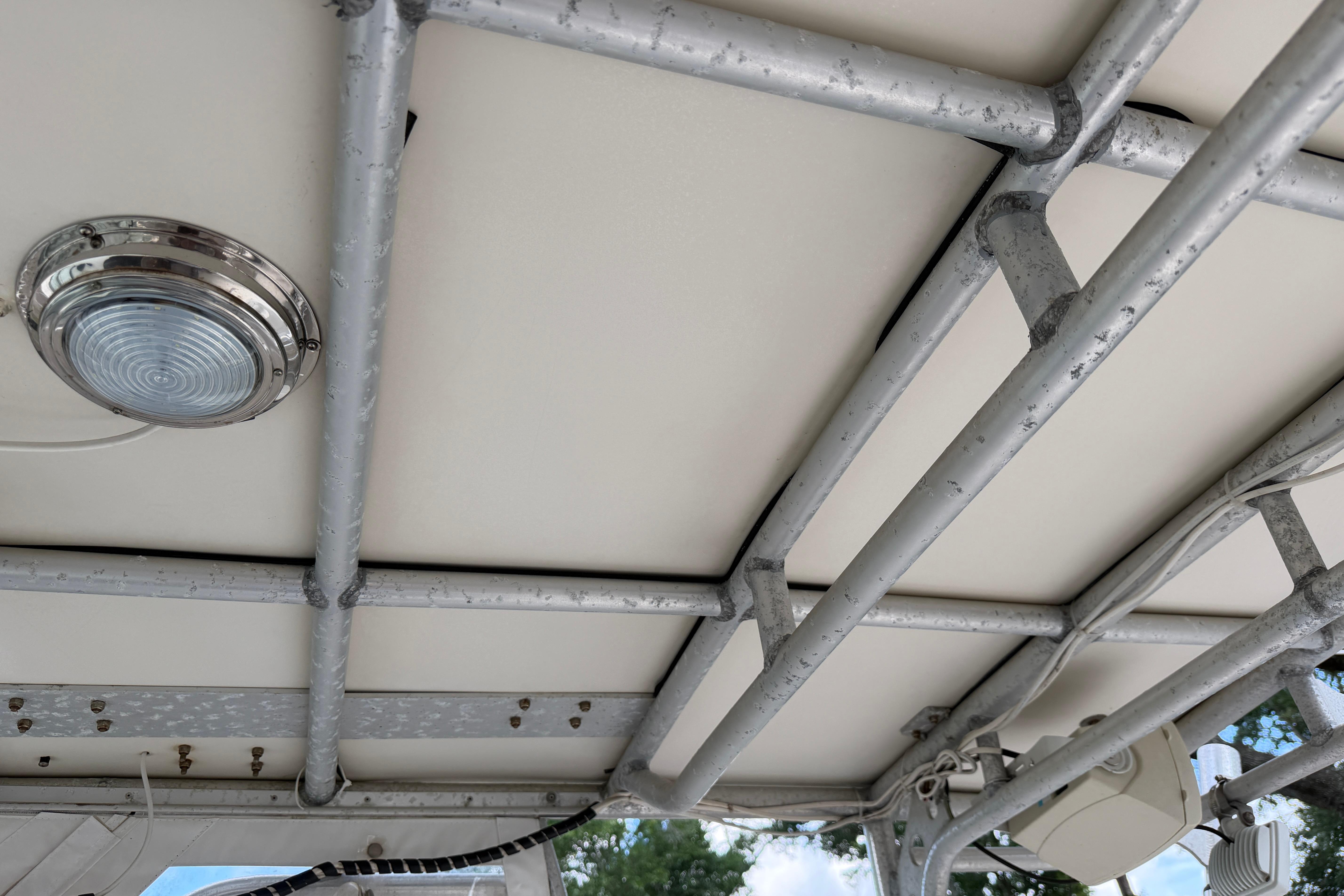 1987 Grady-White Seafarer 226 boat canopy with metal framework and light fixture.