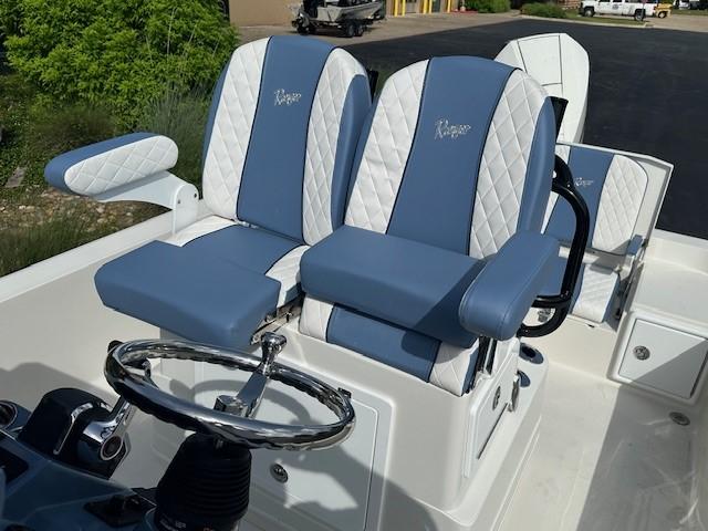 2025 Ranger 2360 Bay boat seats with blue and white upholstery, featuring a sleek steering wheel.
