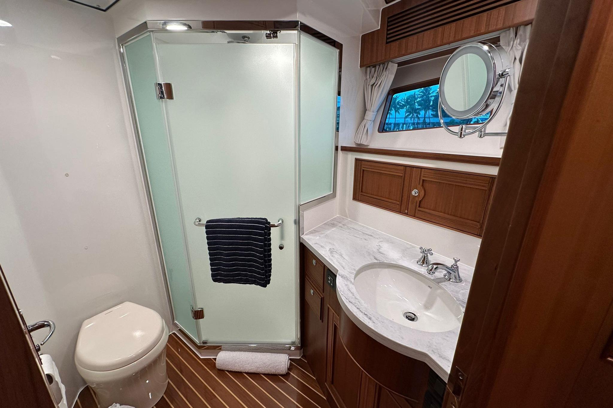 Luxurious bathroom in 2023 Marlow Explorer 66E-CB yacht with modern fixtures and elegant design.