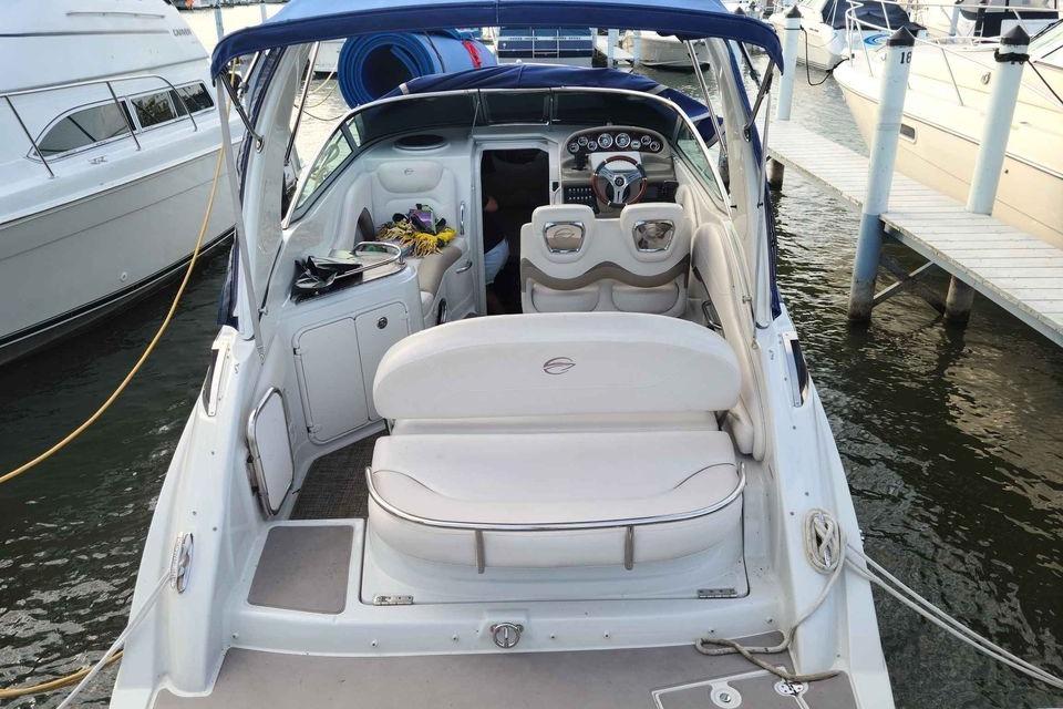 2016 Crownline 264 CR boat docked, featuring spacious seating and modern dashboard.