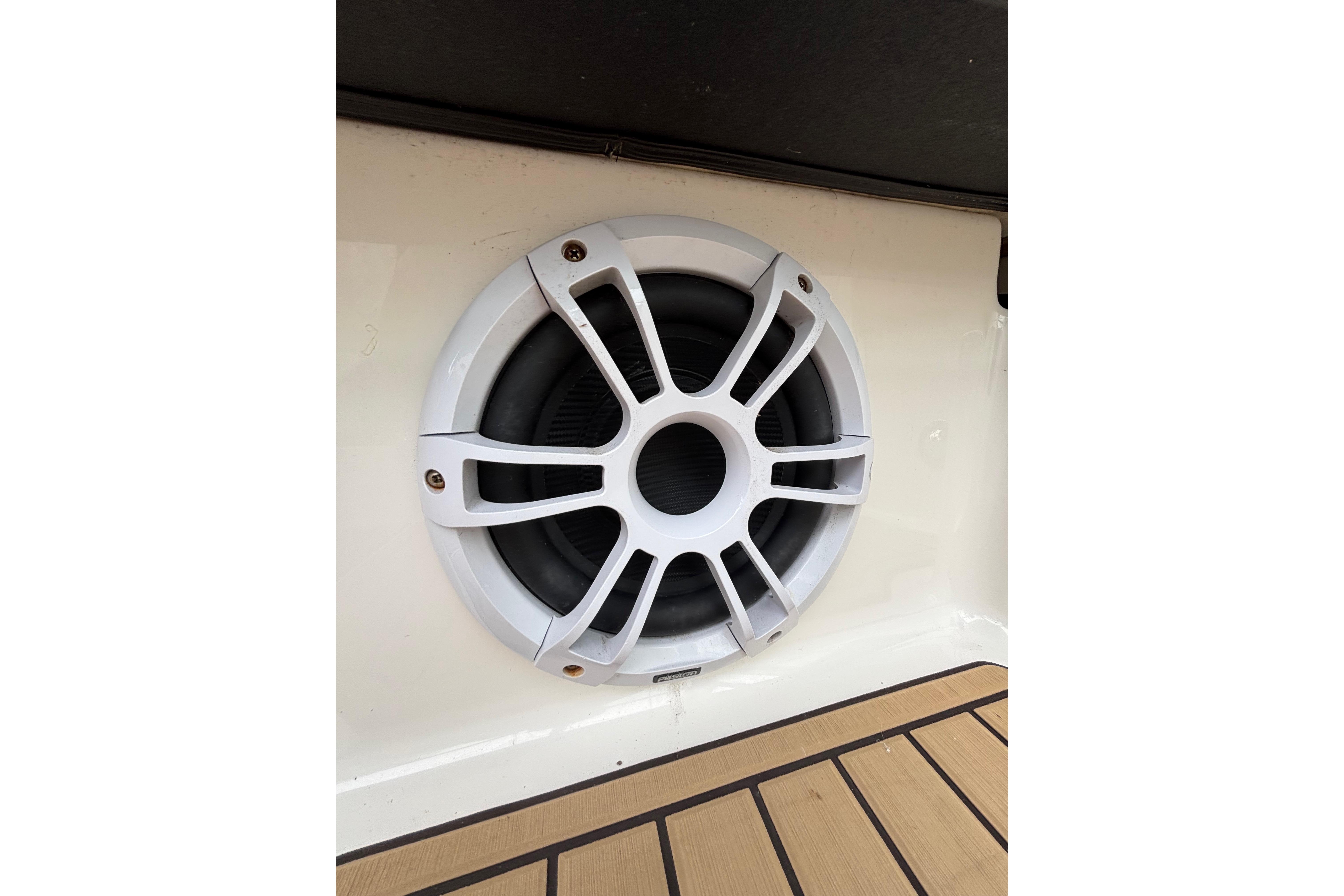 Speaker on 2021 Sea Ray Sundancer 320 Outboard boat, featuring sleek design and wood flooring.