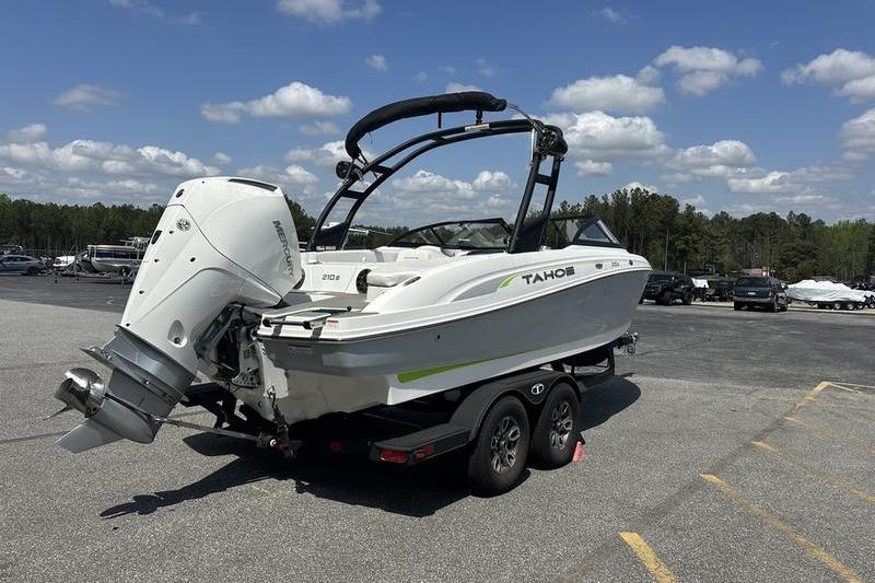 2024 Tahoe 210 S boat on trailer, parked outdoors under a clear sky.