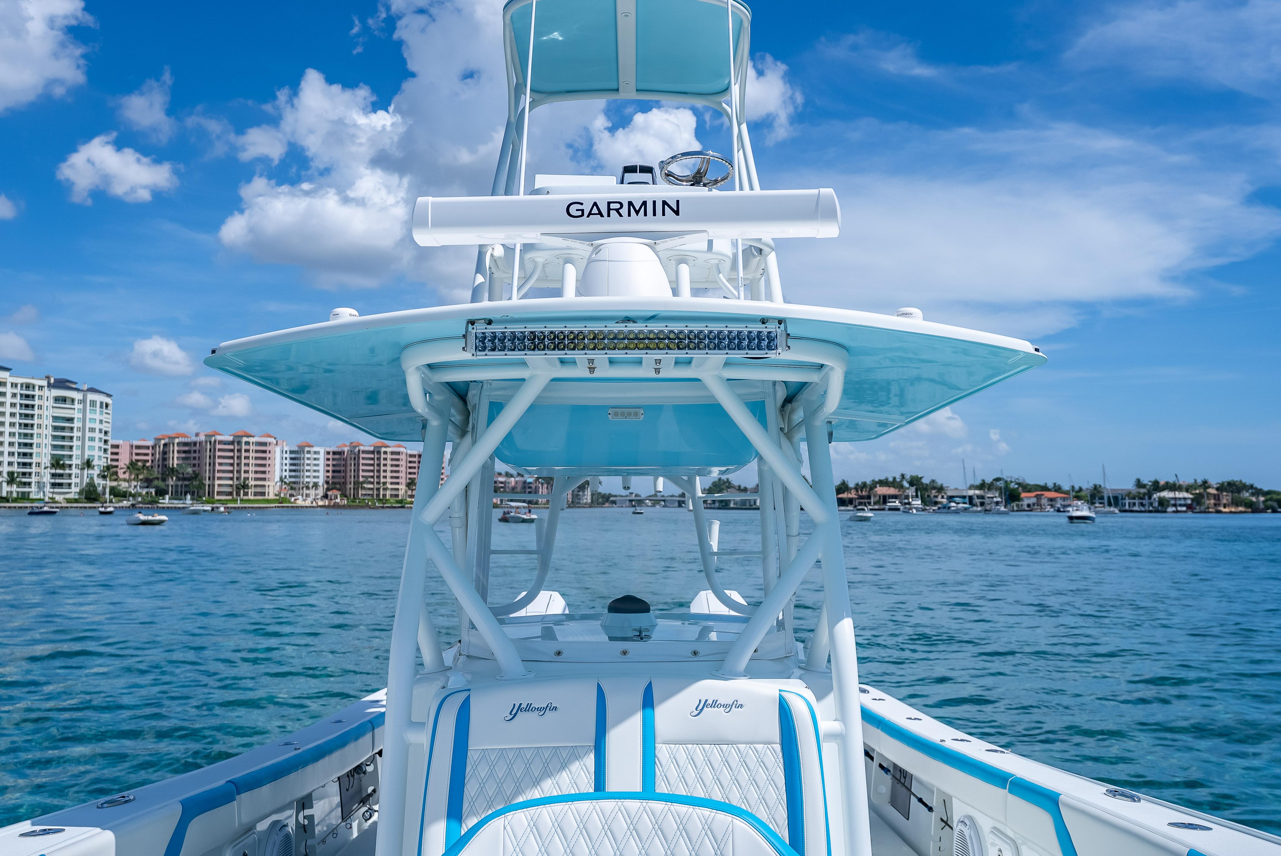 2016 Yellowfin 39 Offshore boat on water, clear sky, coastal buildings in background.