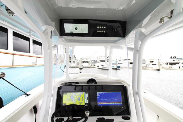 2024 Jupiter 34 HFS boat dashboard with navigation screens at a marina.