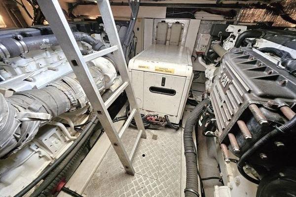 Engine room of 2005 Sunseeker Manhattan 66 yacht with visible machinery and ladder.